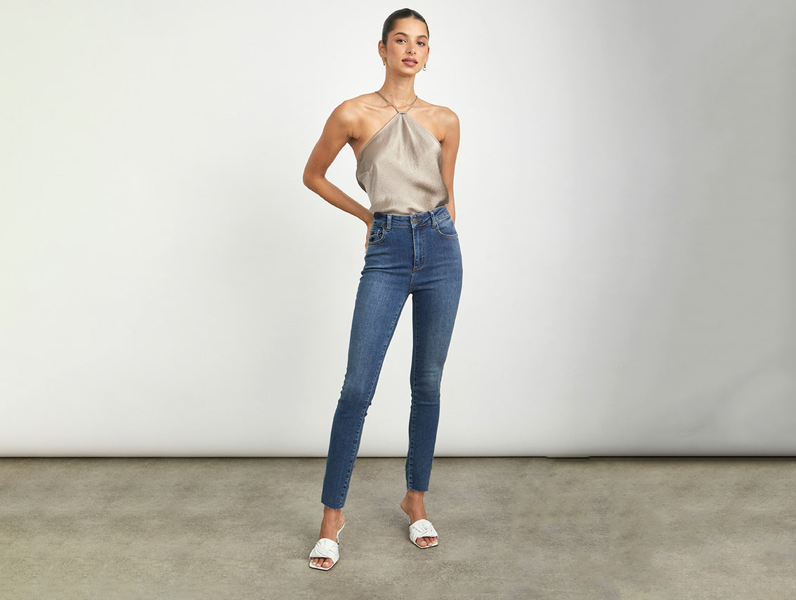 FRONT FULL BODY SHOT OF MODEL WEARING THE LARCHMONT SKINNY JEAN WITH A HALTER TOP