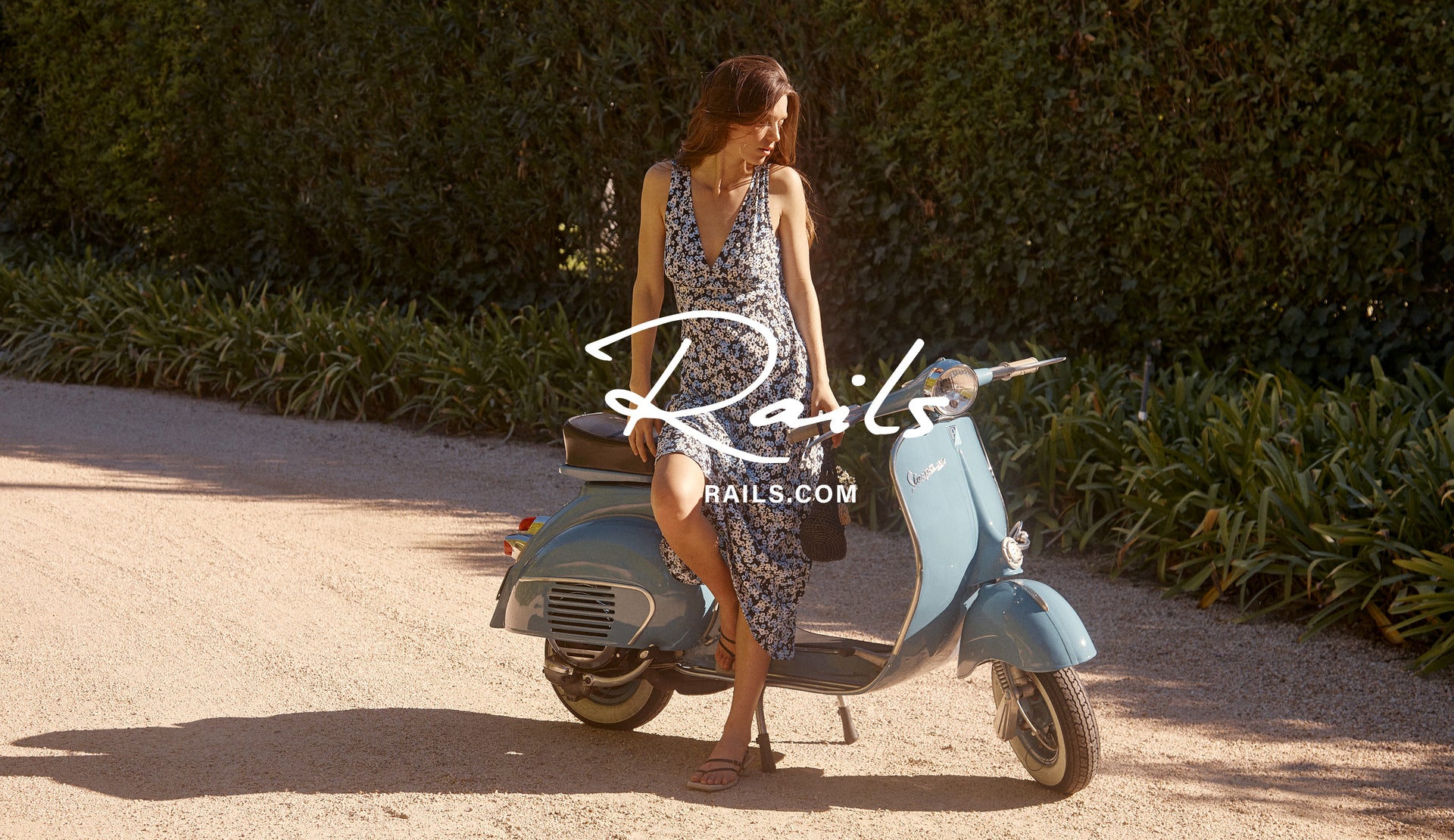 FRONT FULL BODY EDITORIAL IMAGE OF MODEL ON VESPA WEARING AUDRINA DRESS