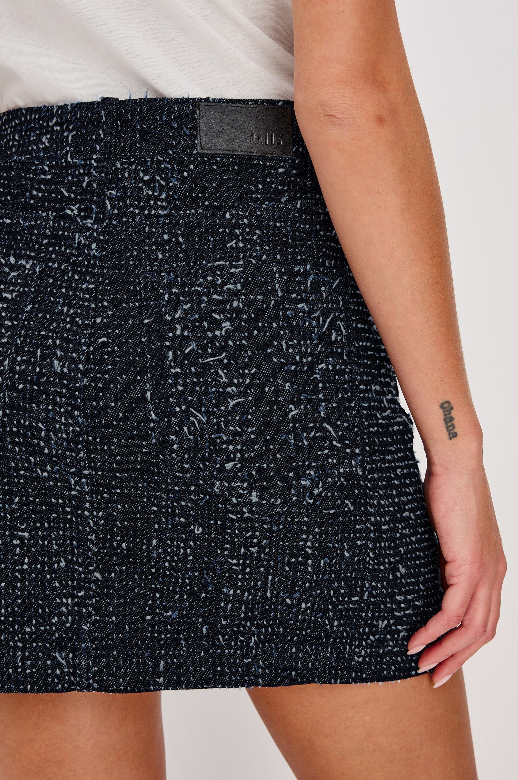 Abbot Mini Skirt in Rigid Denim With Tweed Texture With High-Rise High-Waisted Fit, Front Button Flap Pockets, and Front Zip Closure - Full Body Front View Featured on Model