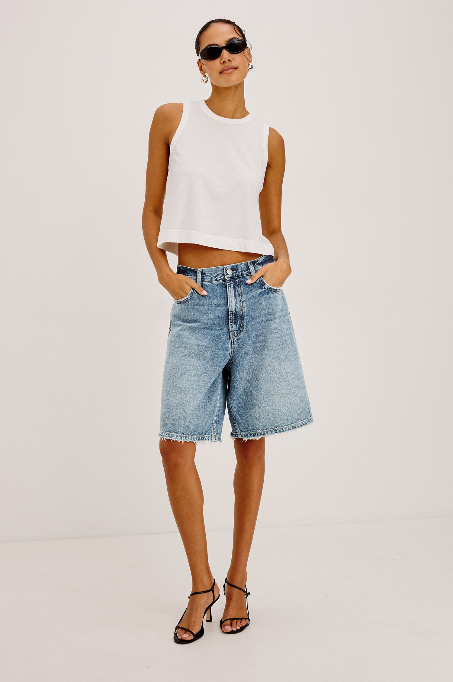 Agoura Short in Rigid Denim With Wide Leg, Relaxed, Low-Slung Fit, Distressed Detailing, Zip Fly, Belt Loops, and 5-Pockets in Authentic Stone Colorway - Full Body Front View Featured on Model