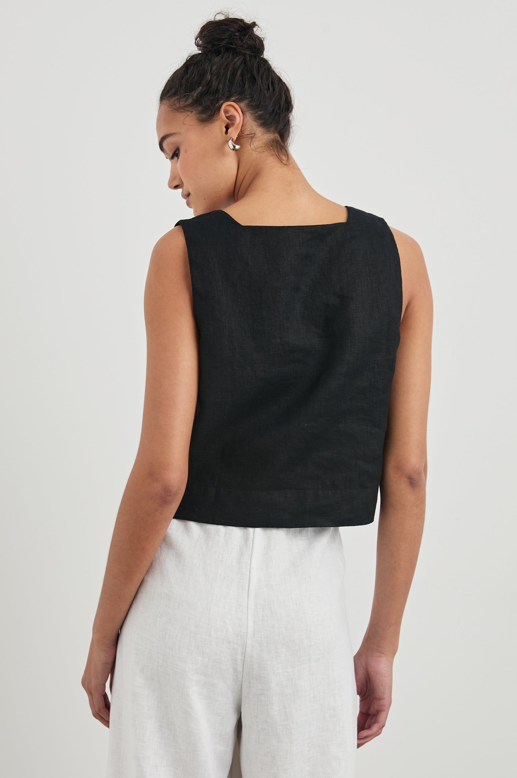 Akira Sleeveless Crop Top with Square Neckline and Wide Shoulder Straps in Black Colorway - Back View Featured on Model 