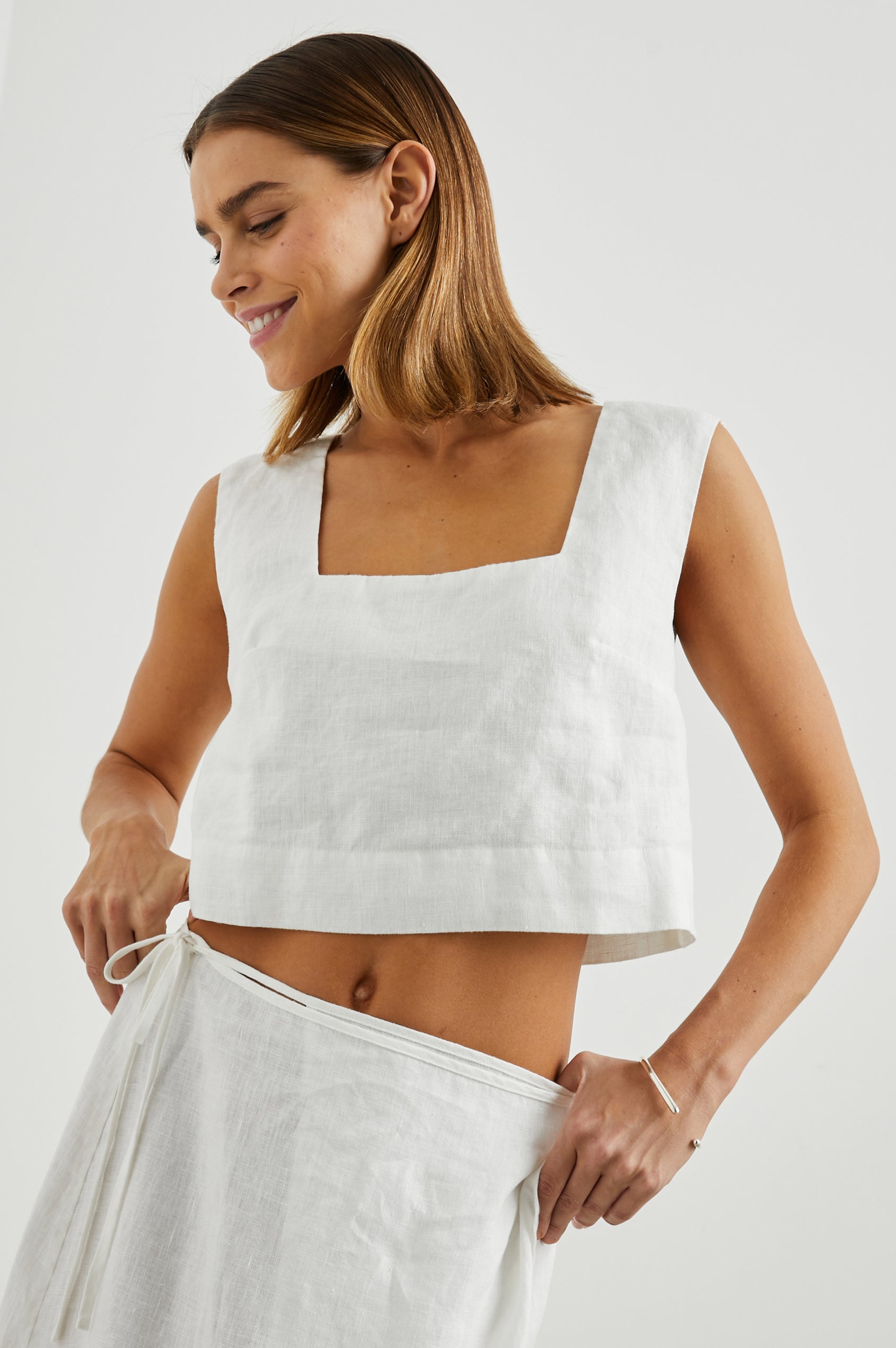 Akira Sleeveless Crop Top with Square Neckline and Wide Shoulder Straps in White Colorway - Front View Featured on Model 