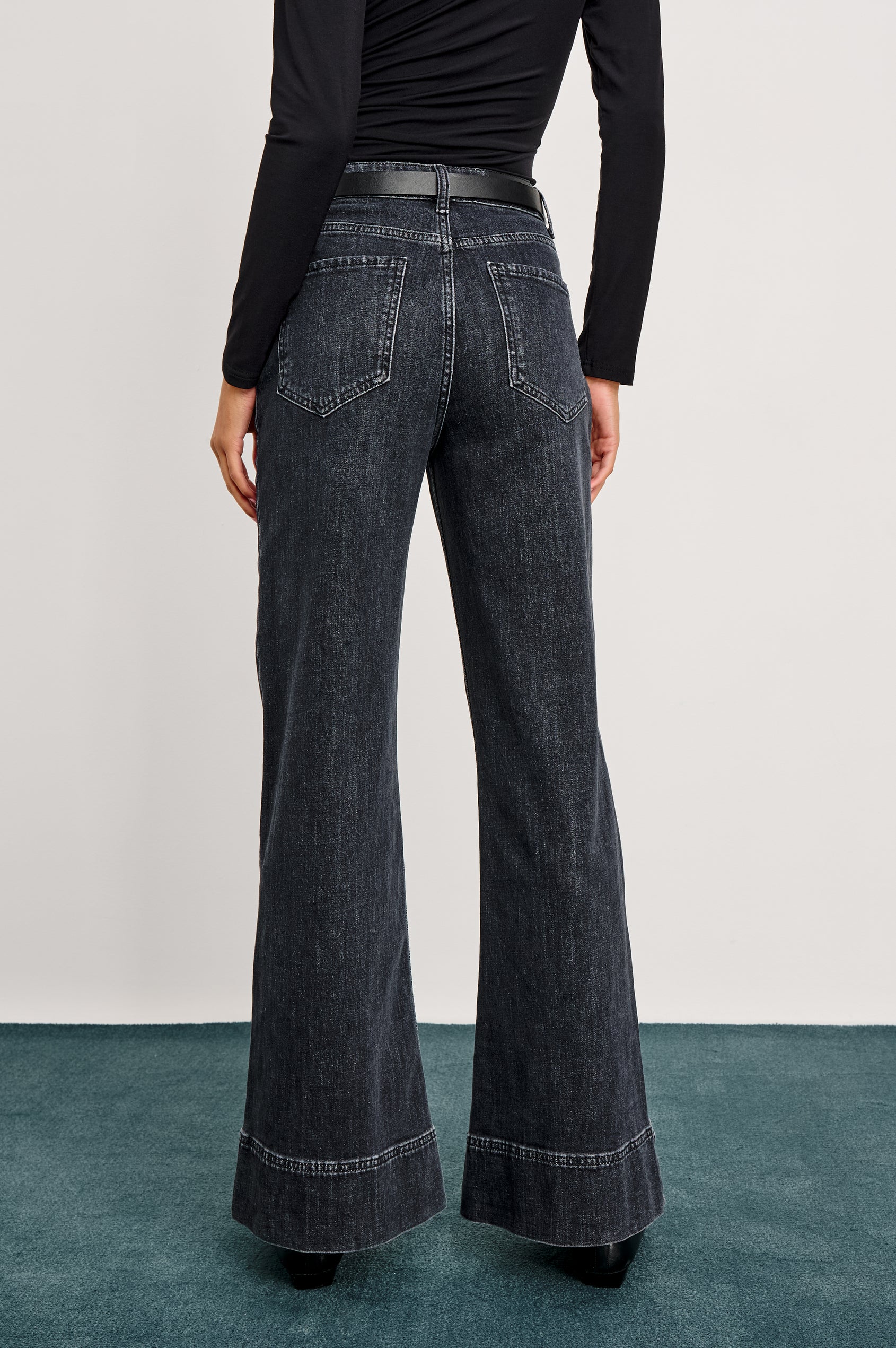 Alamitos high waisted denim trouser with flared leg and front patch pockets in Black Pearl colorway- back view on model