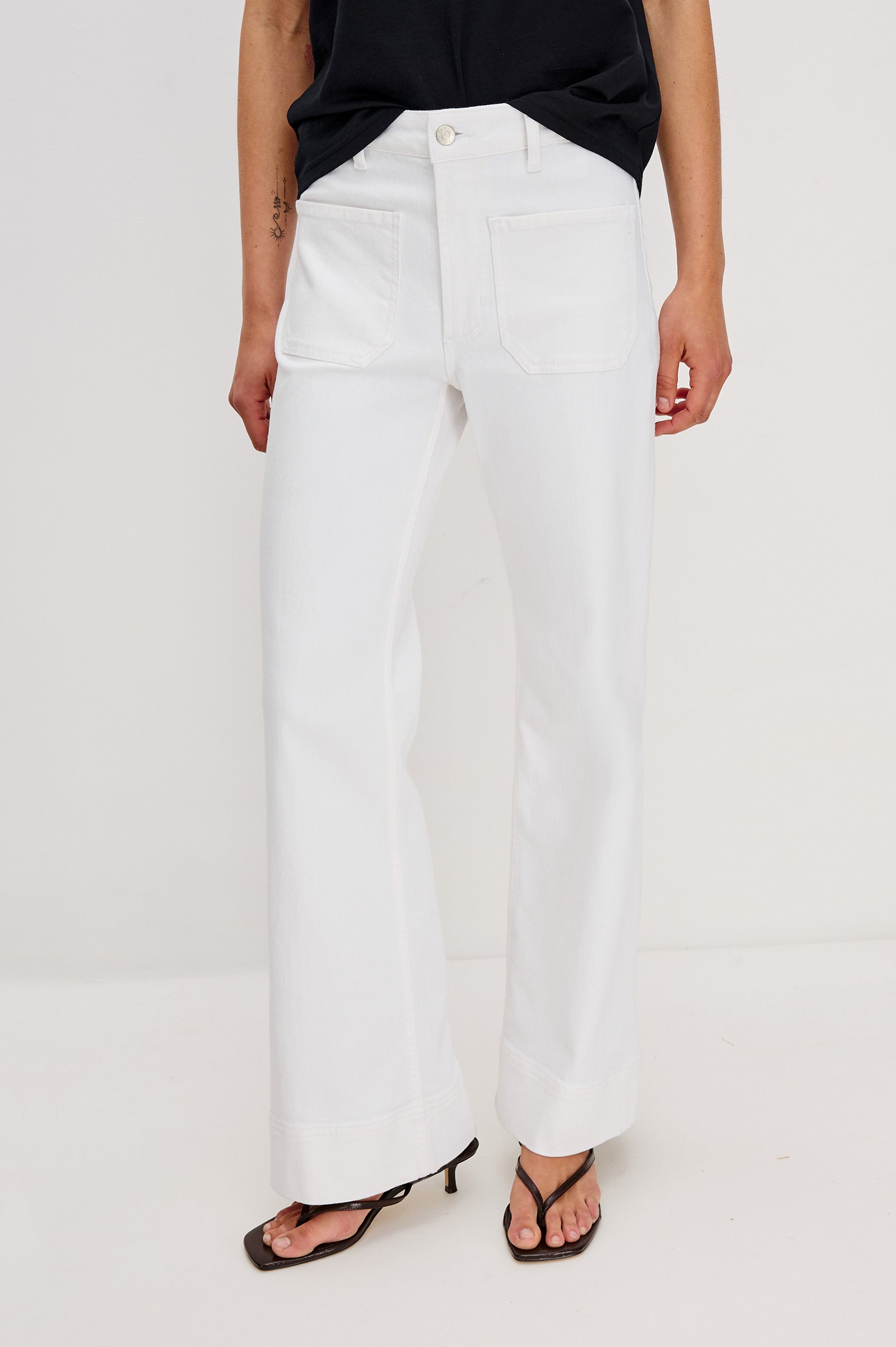 Alamitos Flared Denim Pant with Front Patch Pockets, Belt Loops and Zipper Button Fly in Salt White Colorway. Front View Shown on Model.