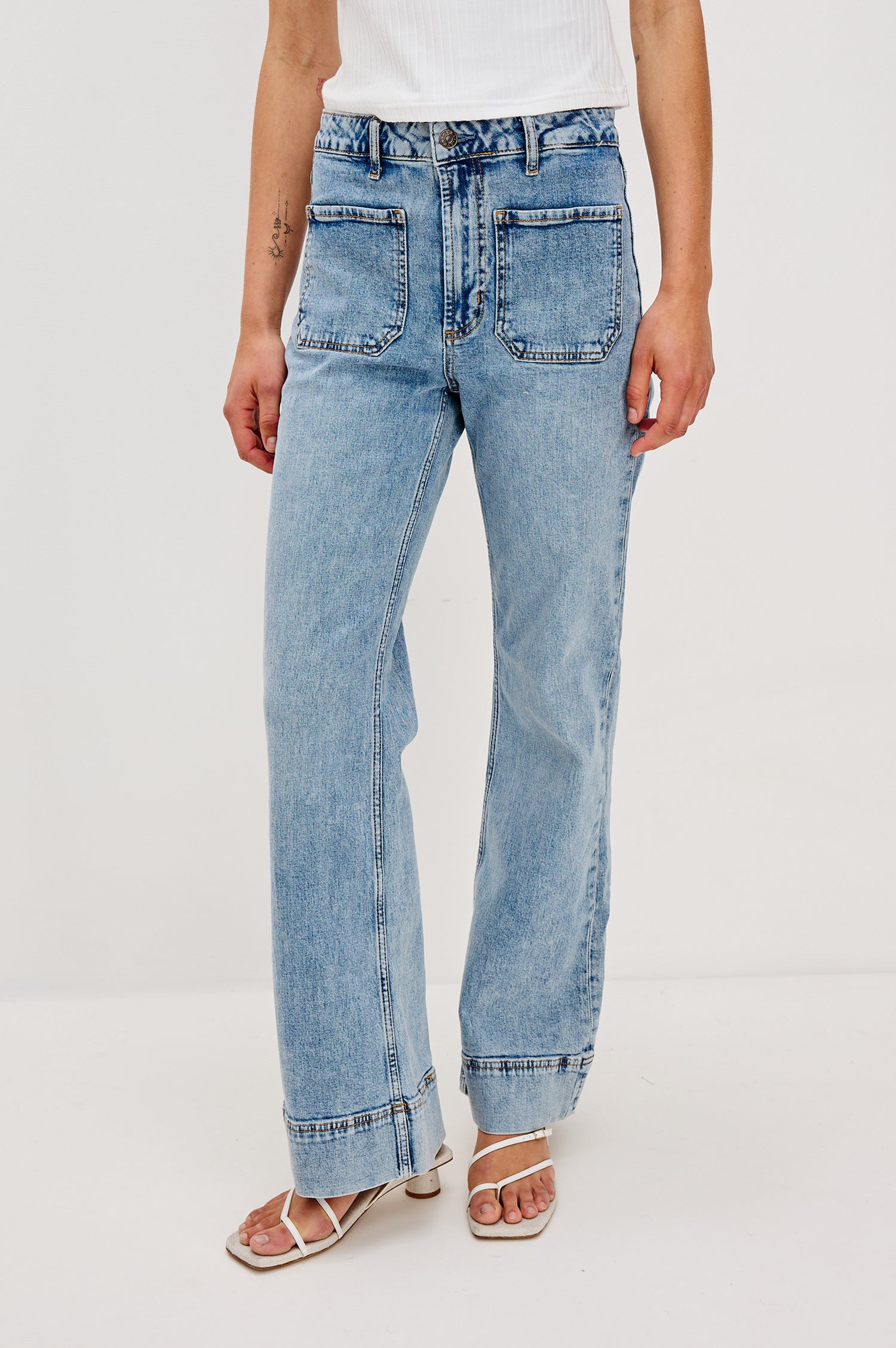Alamitos high waisted denim trouser with flared leg and front patch pockets in Serenity - front view on model