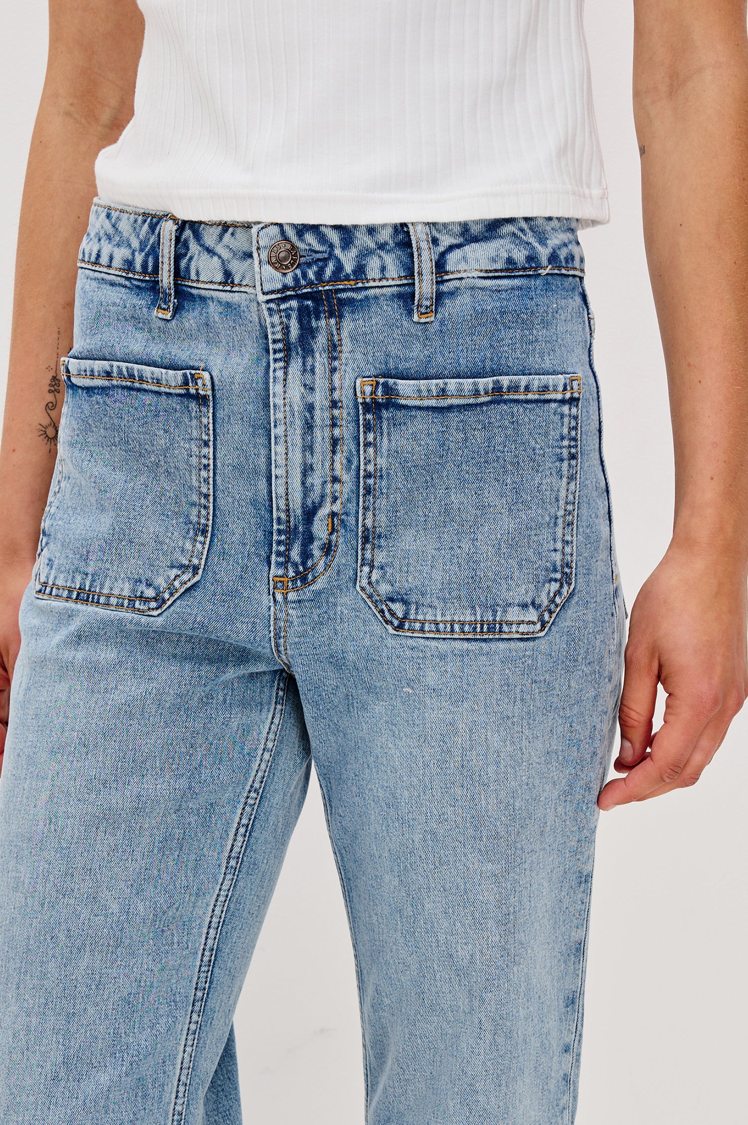 Alamitos high waisted denim trouser with flared leg and front patch pockets in Serenity - close up of pocket details on model