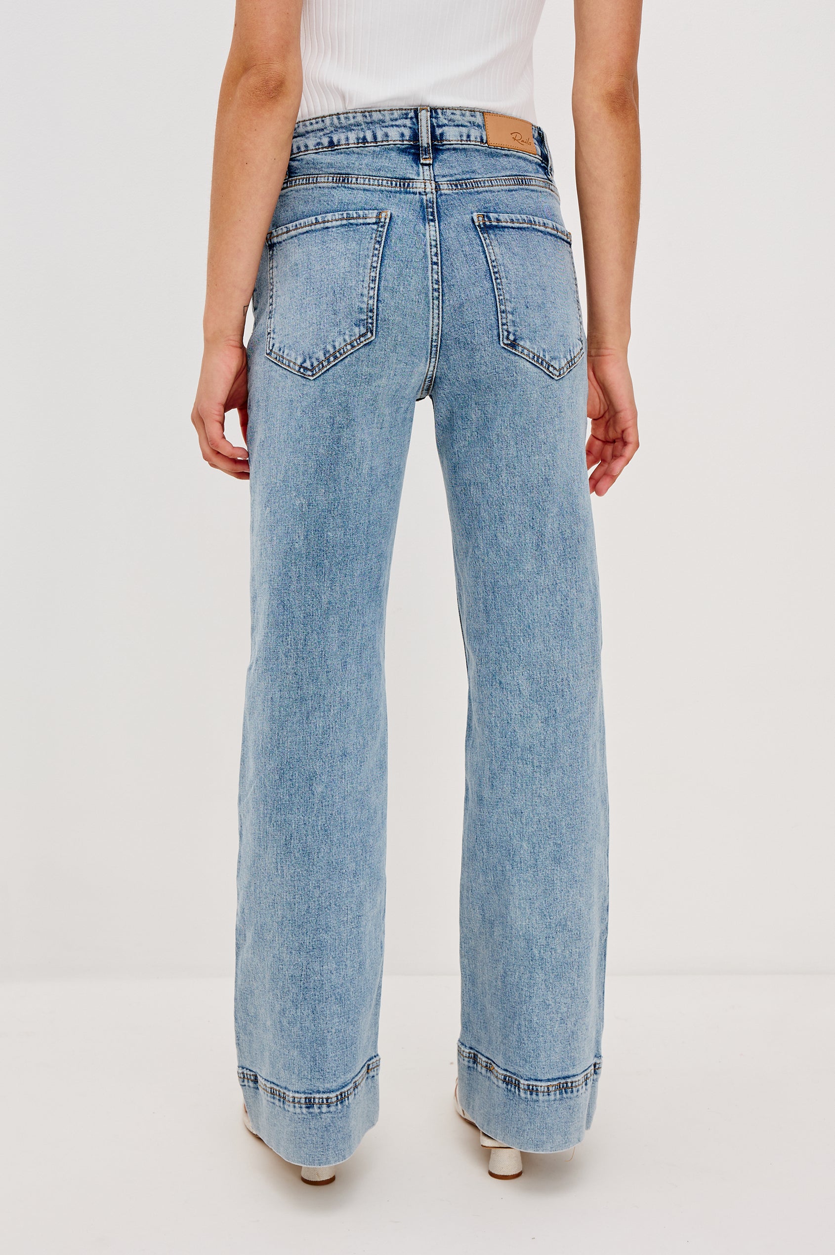 Alamitos high waisted denim trouser with flared leg and front patch pockets in Serenity - back view on model