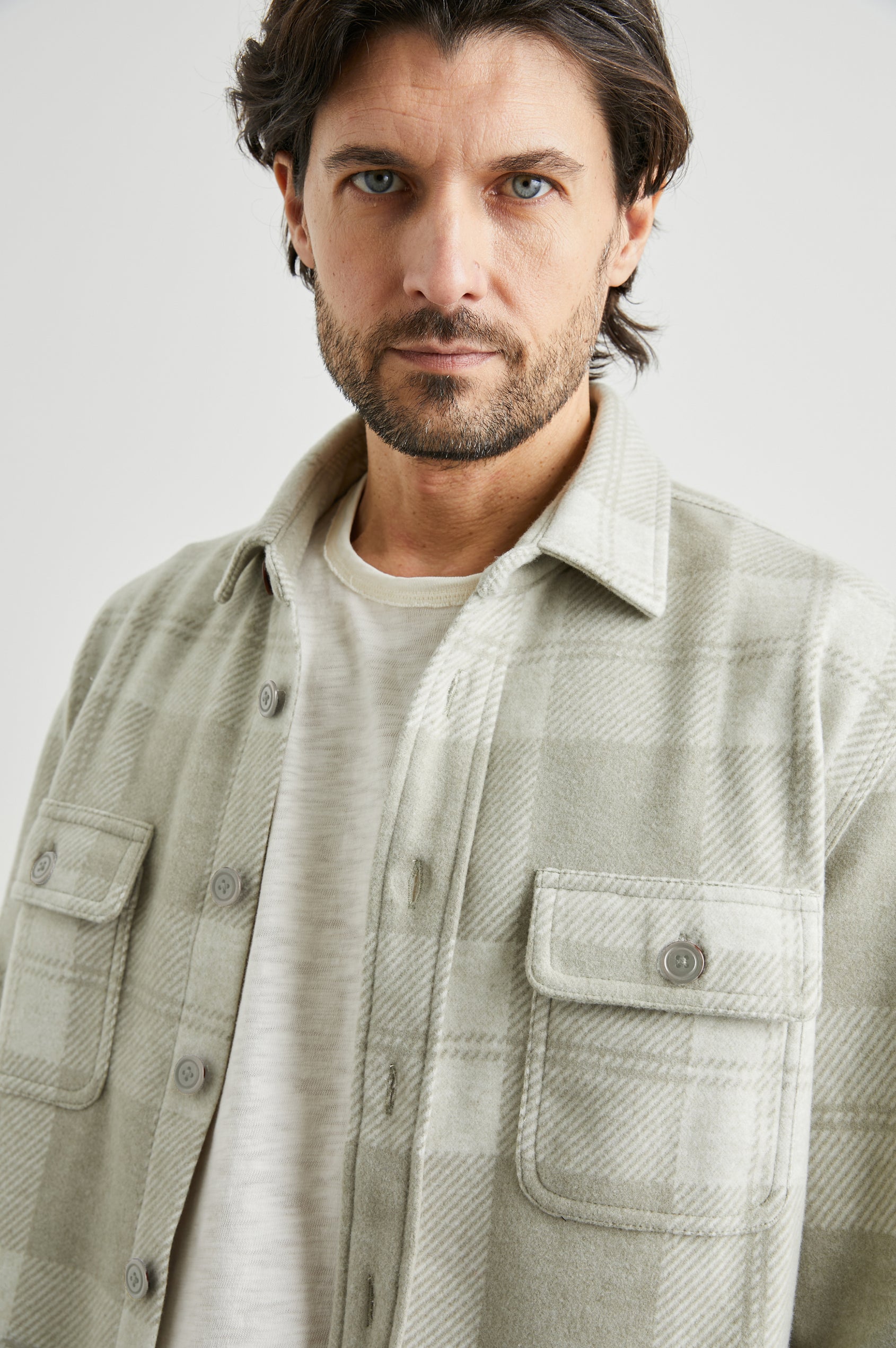 Alder Long-Sleeve Button up with Two Buttoned Chest Flap Pockets in Fawn Cream Colorway, a plaid - Front Unbuttoned View Featured on Model