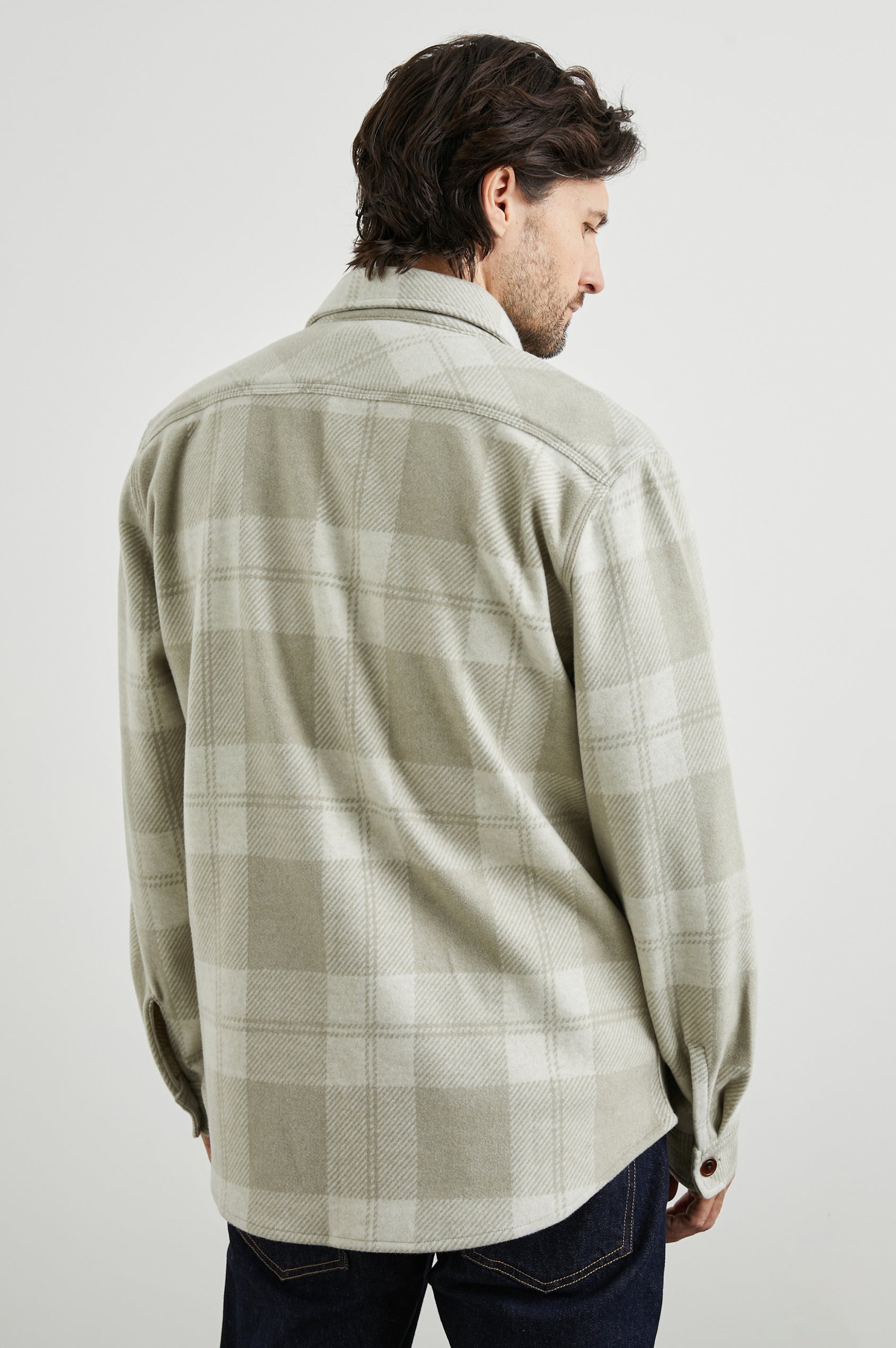 Alder Long-Sleeve Button up with Two Buttoned Chest Flap Pockets in Fawn Cream Colorway, a plaid - Back Unbuttoned View Featured on Model