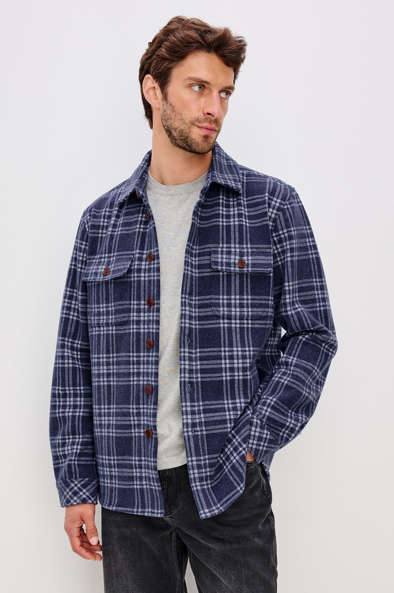 Alder Long-Sleeve Button up with Two Buttoned Chest Flap Pockets in Frost Harbor Colorway, a Blue and White plaid. Front Unbuttoned View Featured on Model