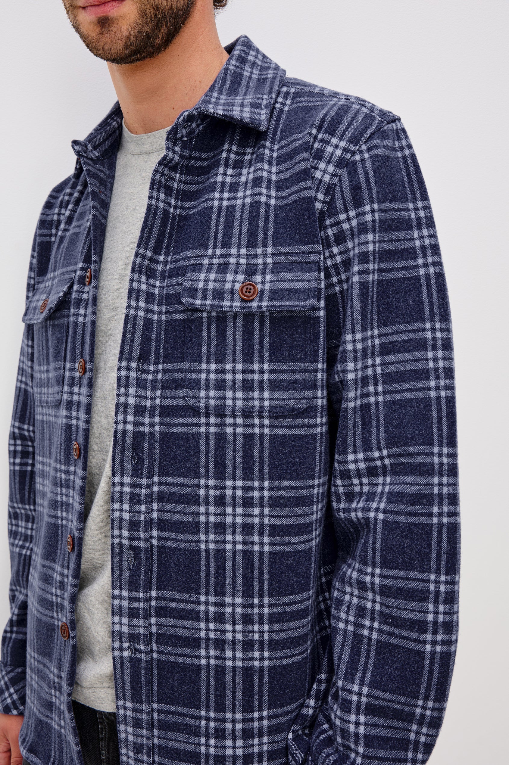 Alder Long-Sleeve Button up with Two Buttoned Chest Flap Pockets in Frost Harbor Colorway, a Blue and White plaid. Front Detail View Featured on Model