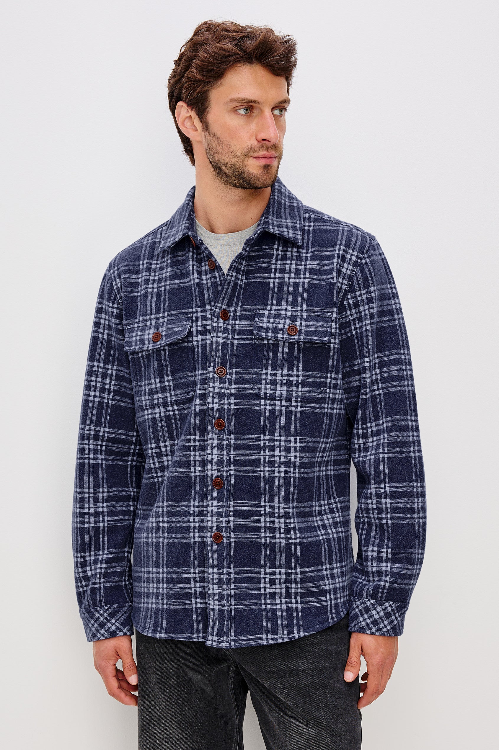 Alder Long-Sleeve Button up with Two Buttoned Chest Flap Pockets in Frost Harbor Colorway, a Blue and White plaid. Front View Featured on Model
