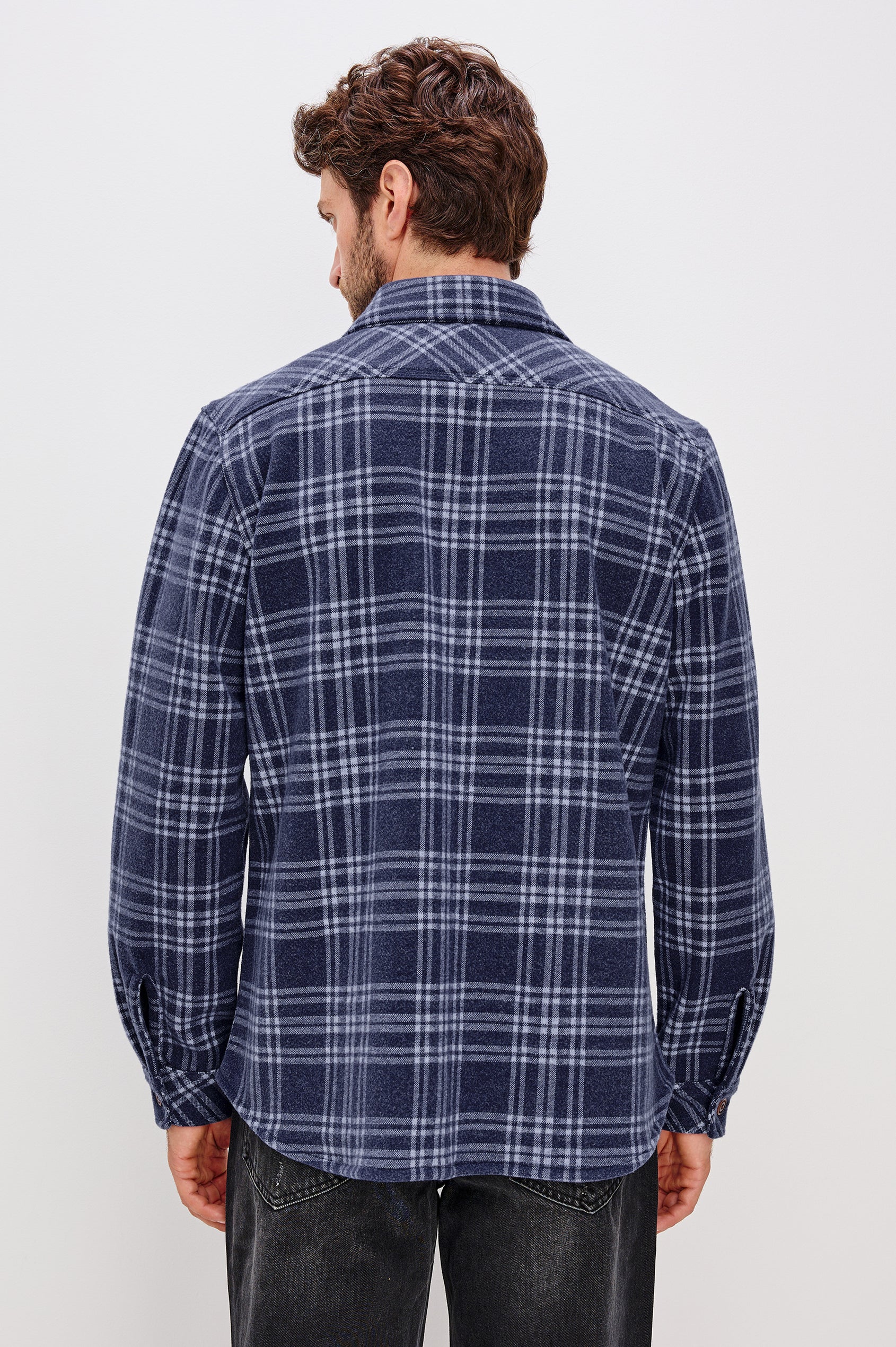 Alder Long-Sleeve Button up with Two Buttoned Chest Flap Pockets in Frost Harbor Colorway, a Blue and White plaid. Back View Featured on Model
