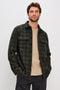 Alder Long-Sleeve Button up with Two Buttoned Chest Flap Pockets in Onyx Surplus Colorway, a Green and Black plaid. Front Unbuttoned View Featured on Model