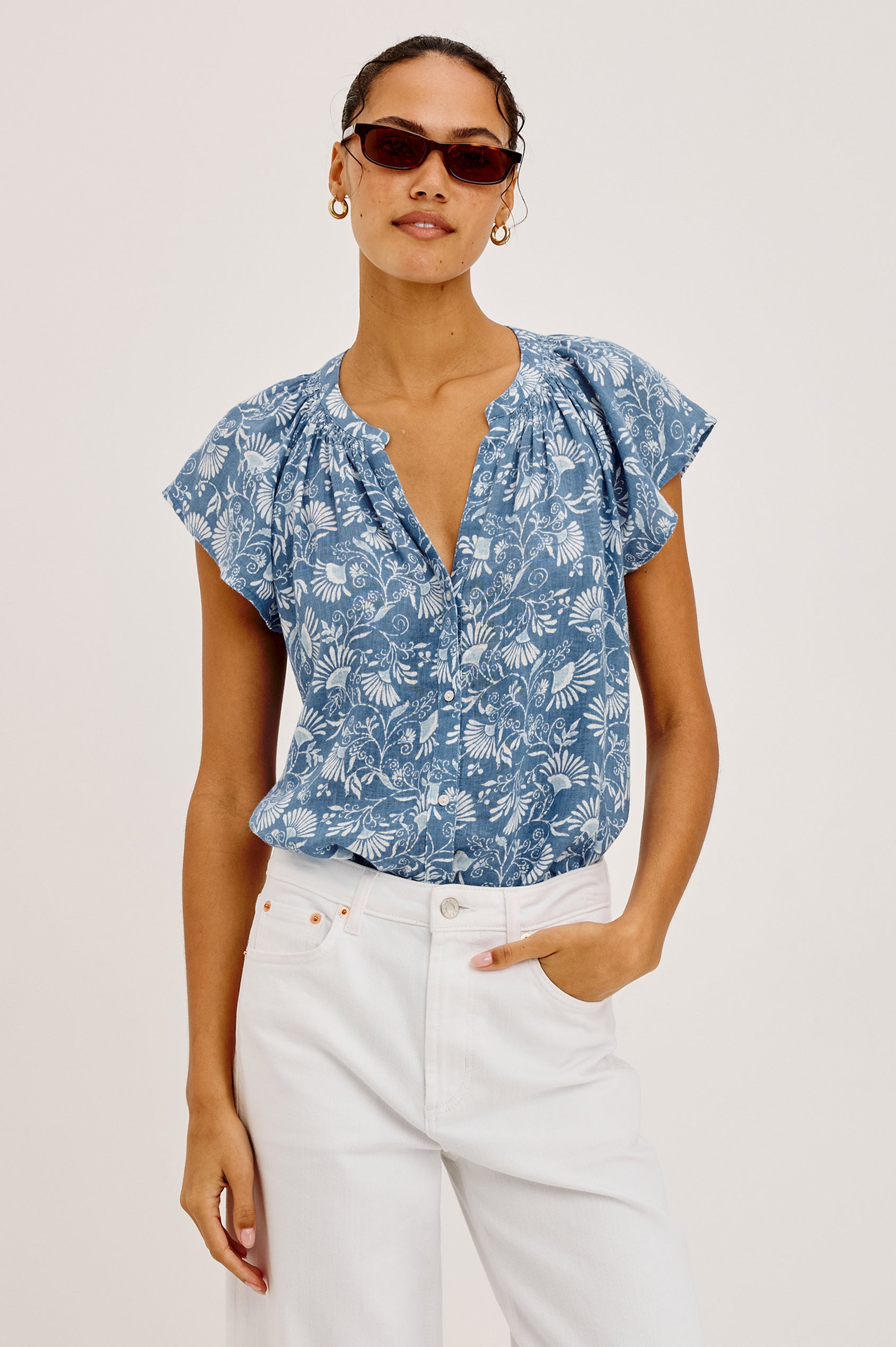 Alena Top in Cotton Gauze With Relaxed Fit, Smocked Split Neckline, Cap Sleeves, and Front Button Placket in Blue Cassia Colorway - Upper Body Front View Featured on Model