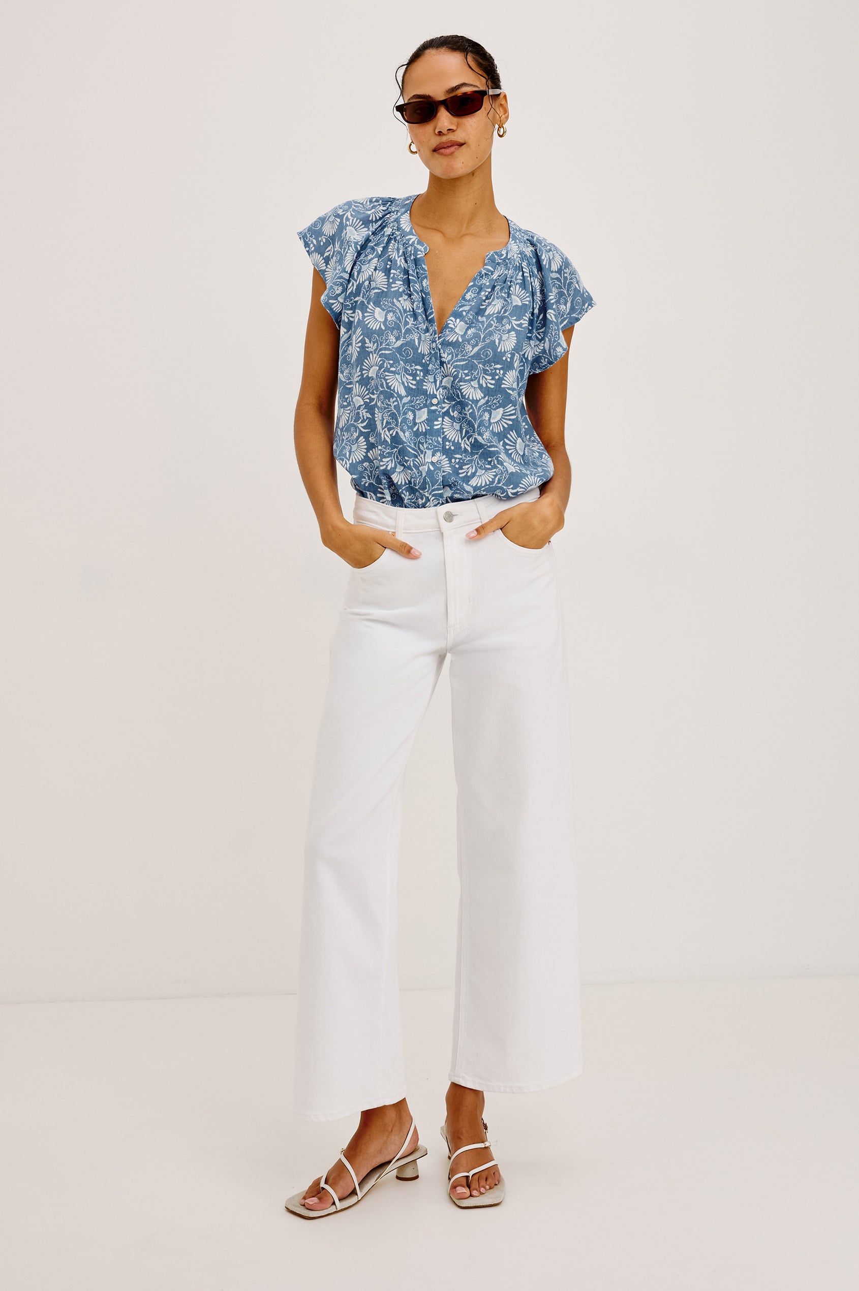 Alena Top in Cotton Gauze With Relaxed Fit, Smocked Split Neckline, Cap Sleeves, and Front Button Placket in Blue Cassia Colorway - Full Body Front View Featured on Model