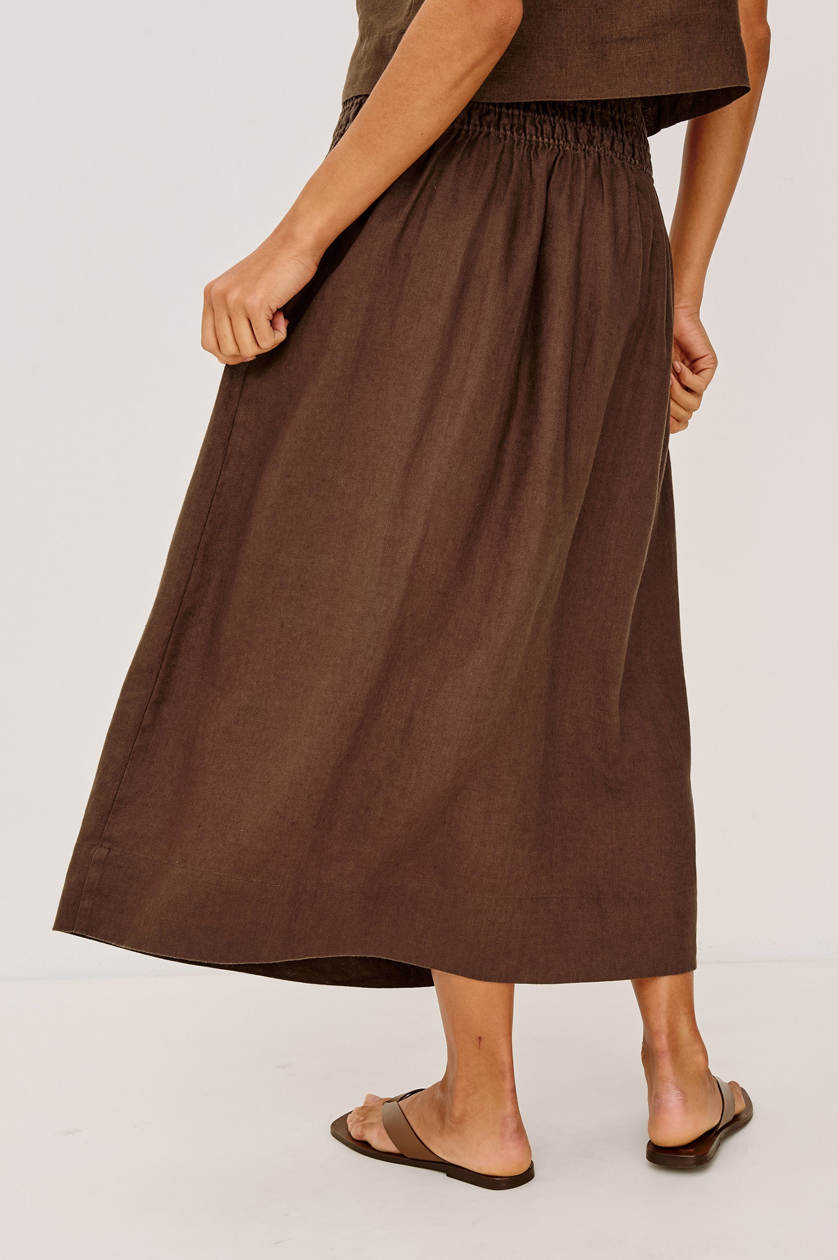 Alessa Midi Skirt in Heavy Linen With Wide Smocked Waistband and A-Line Silhouette in Espresso Colorway - Lower Body Back View Featured on Model