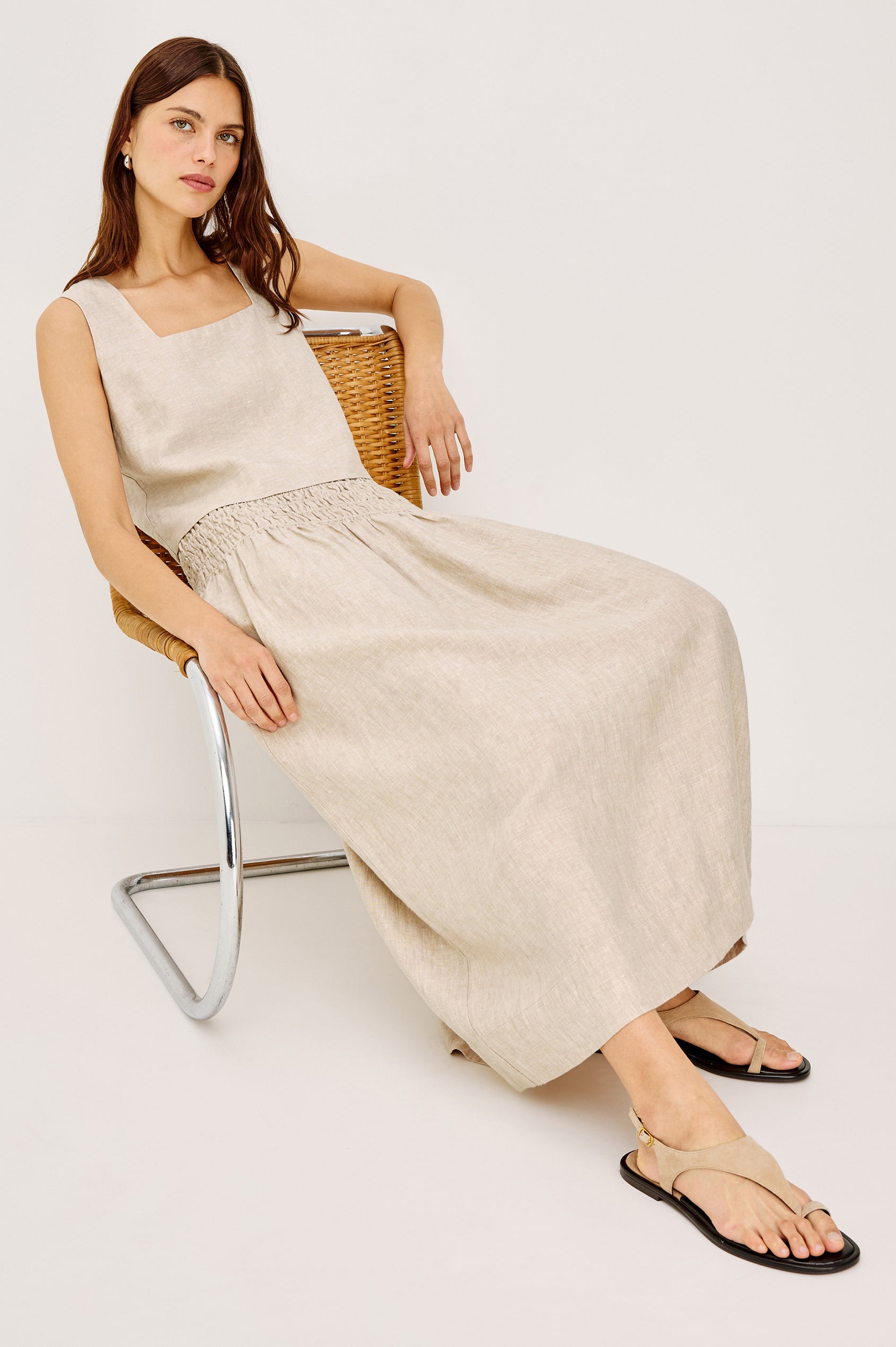 Alessa Midi Skirt in Heavy Linen With Wide Smocked Waistband and A-Line Silhouette in Heathered Flax Colorway - Full Body Front View Featured on Model on Chair
