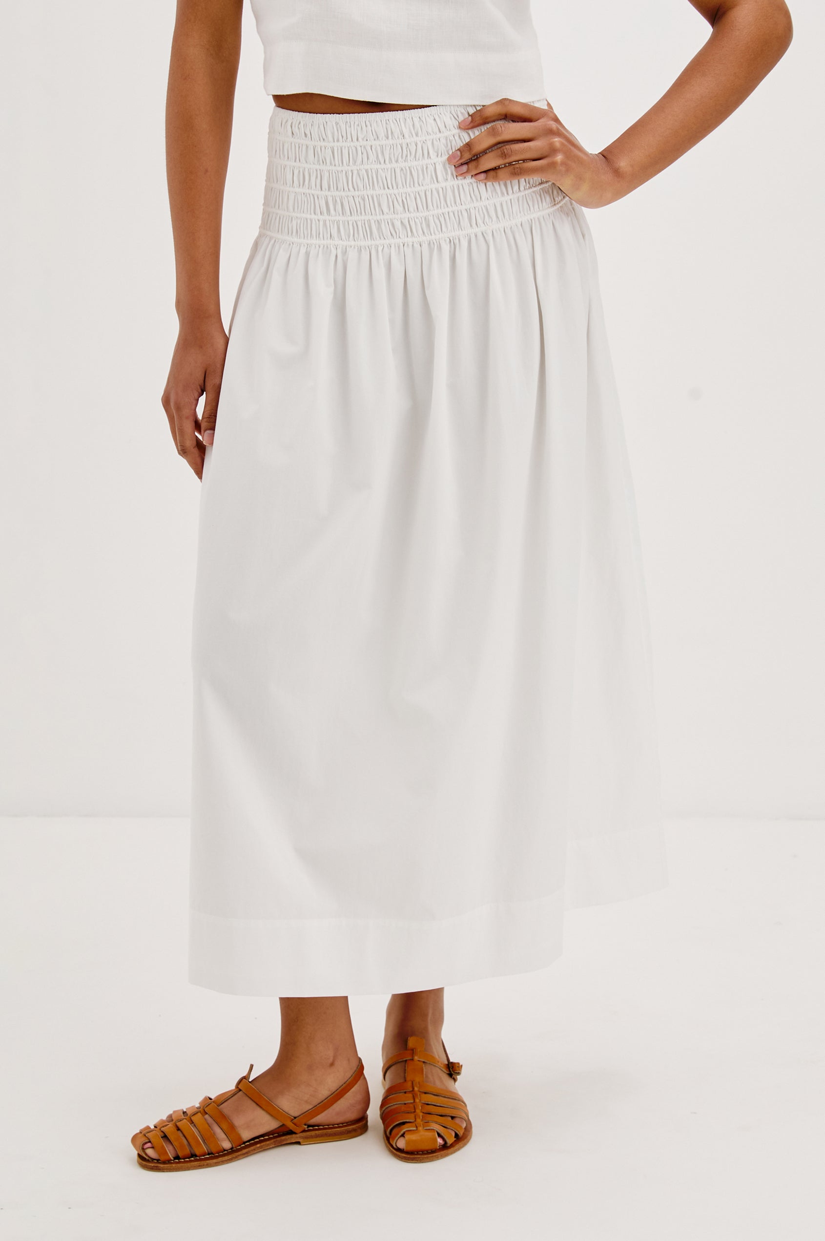 Alessa Midi Skirt with a Wide Elastic Gathered Waistband in White Colorway. Front View Shown on Model.