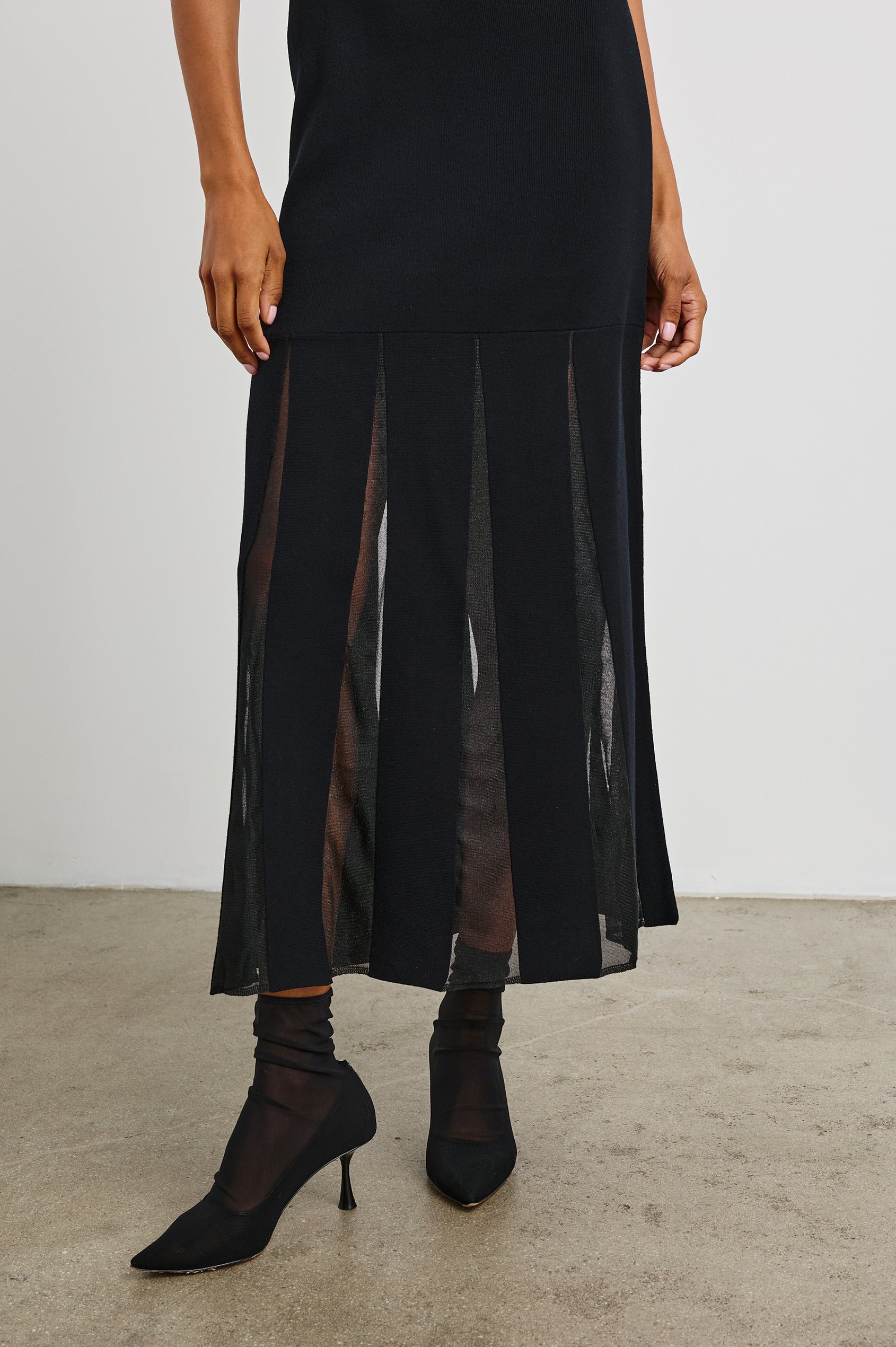 Alessia Sleeveless Maxi Dress with a Crew Neck and Sheer Vertical Inserts along the Hem from the Mid-Thigh in Black Colorway - Front View Featured on Model 