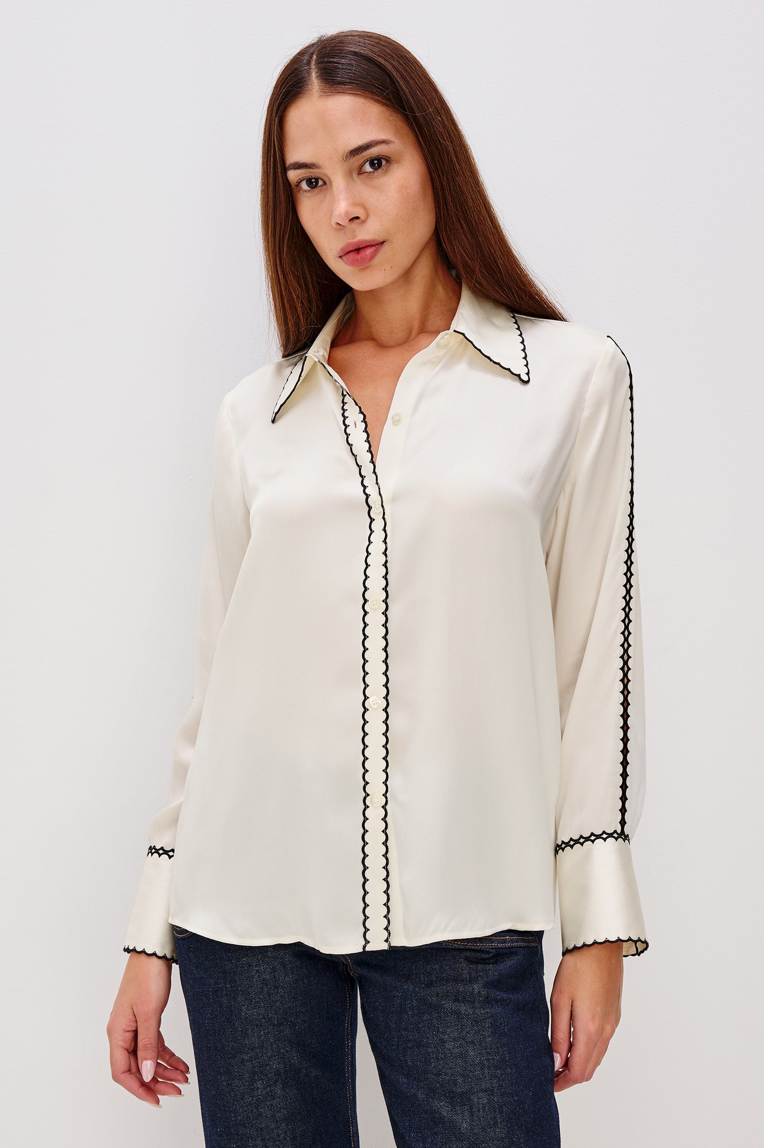 Aloise Collared Shirt in Silk Charmeuse With Scalloped Embroidery, Long Sleeves With Small Cutouts, and Adjustable Front Buttons in Ivory Colorway - Front View Featured on Model