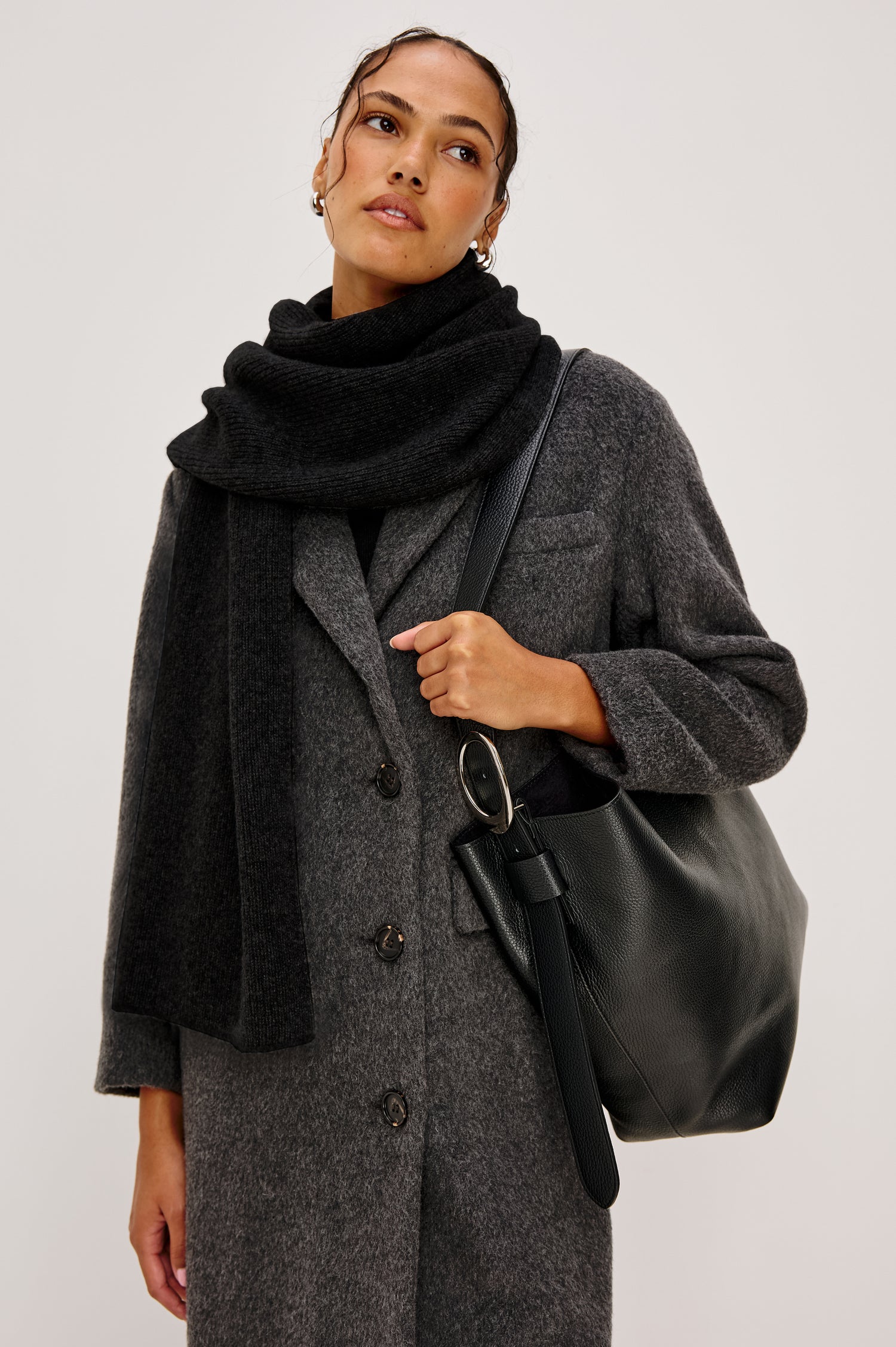 Alps knitted cashmere blend scarf in Black coloraway. Front view featured on model.