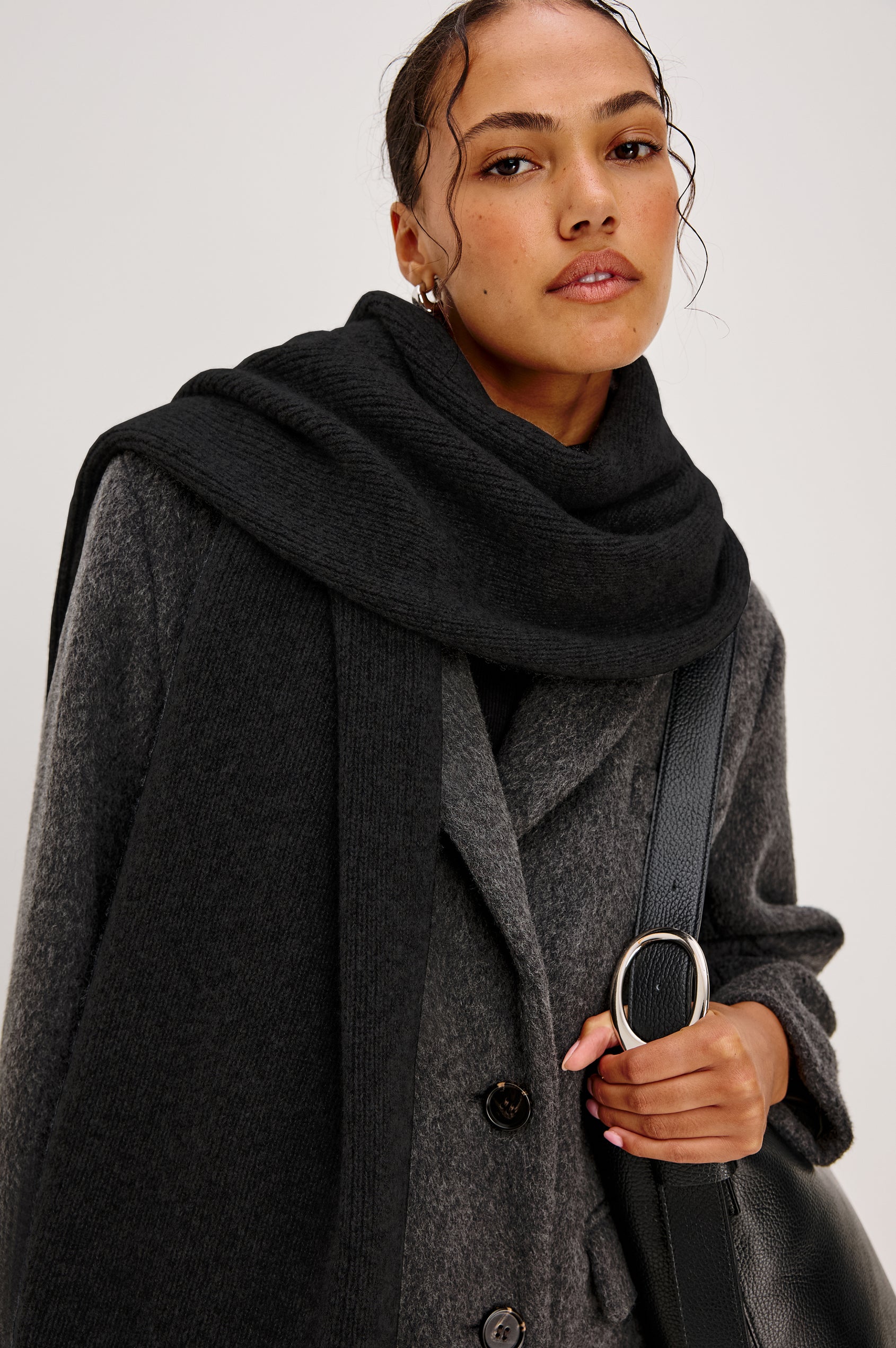 Alps knitted cashmere blend scarf in Black coloraway. Front detail view featured on model.