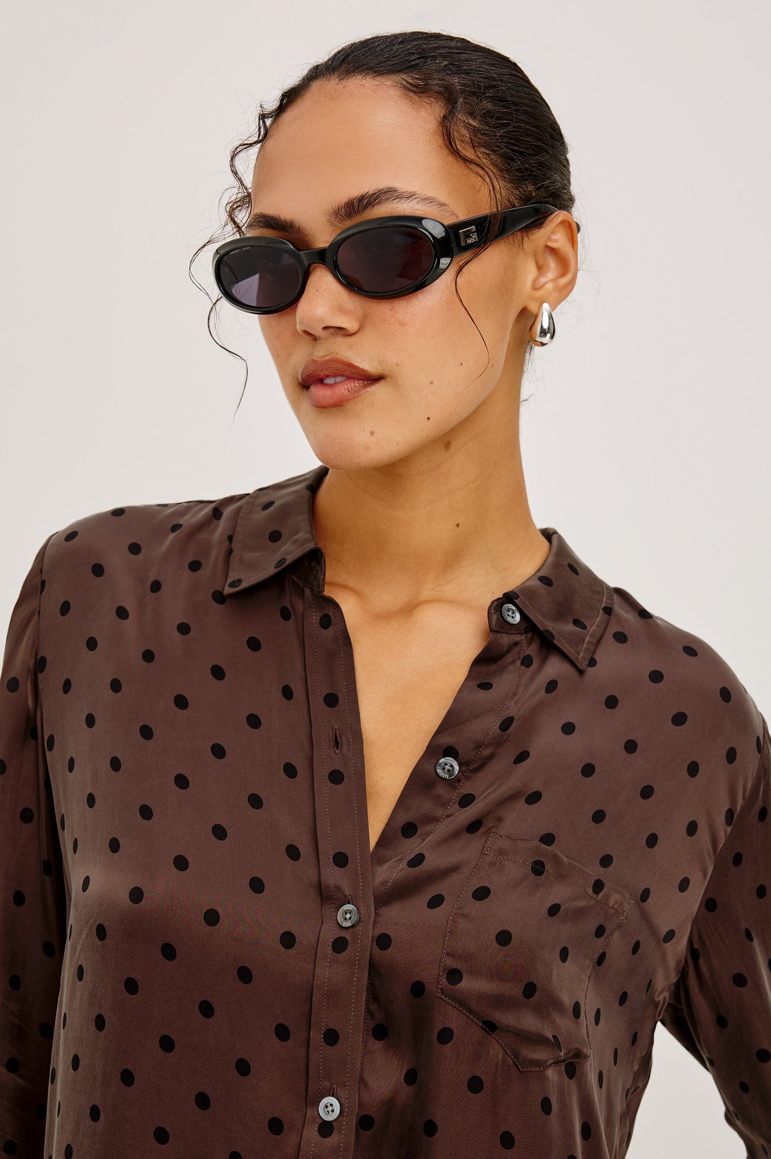 Alyssa Shirt in Luxe Lightweight Cupro With Loose Fit, Collar, Front Buttons, Long Sleeves, and Curved Back Hem in Chocolate Polka Dot Colorway - Upper Body Front View Featured on Model