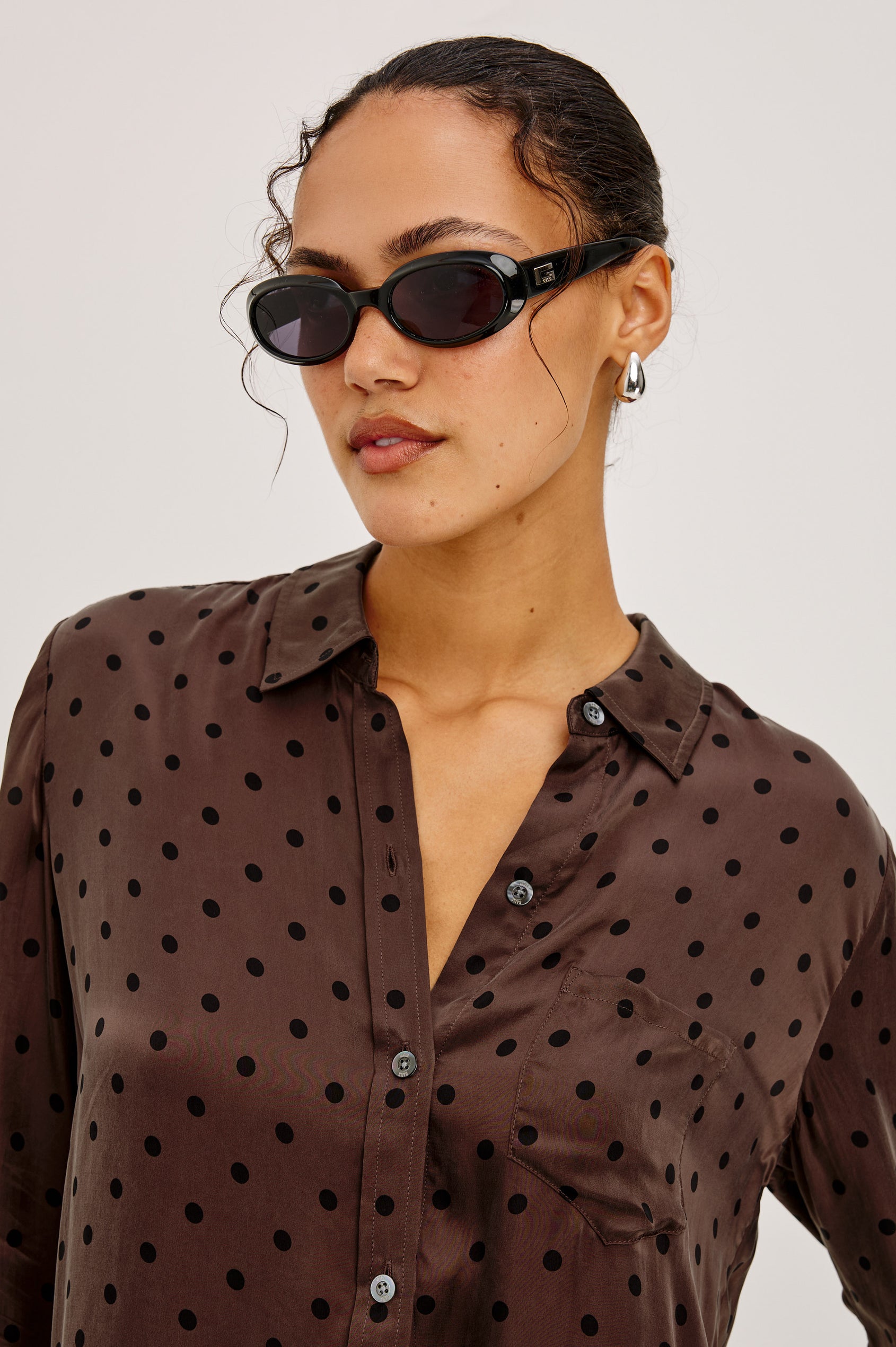 Alyssa Shirt in Luxe Lightweight Cupro With Loose Fit, Collar, Front Buttons, Long Sleeves, and Curved Back Hem in Chocolate Polka Dot Colorway - Upper Body Front View Featured on Model