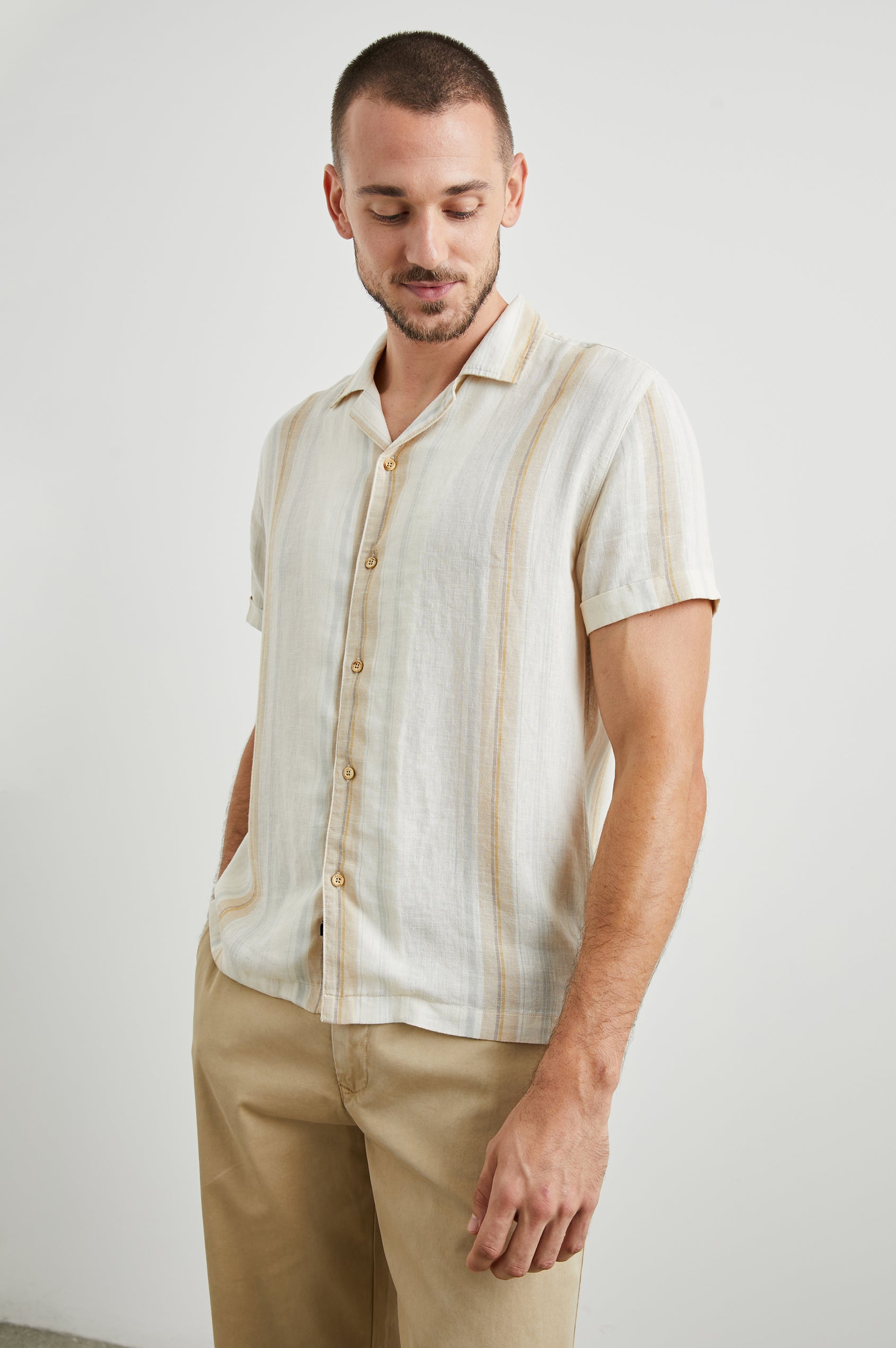 Amalfi Short-Sleeve Button Up in Farro Dove Stripe Colorway, vertical stripes in faro and pale oranges on Dove - Front View Featured on Model