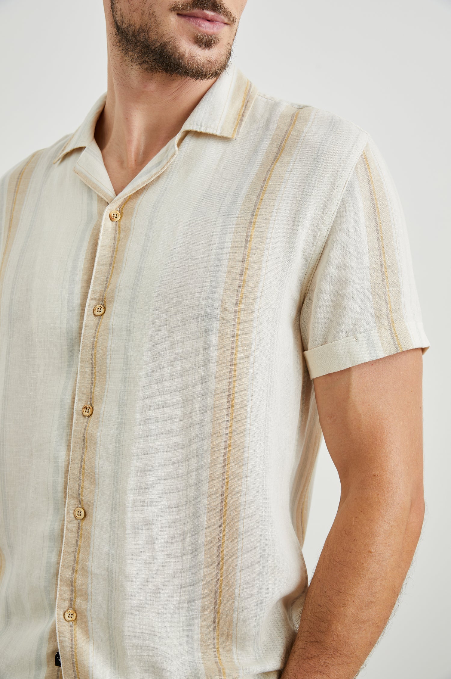 Amalfi Short-Sleeve Button Up in Farro Dove Stripe Colorway, vertical stripes in faro and pale oranges on Dove - Front View Featured on Model