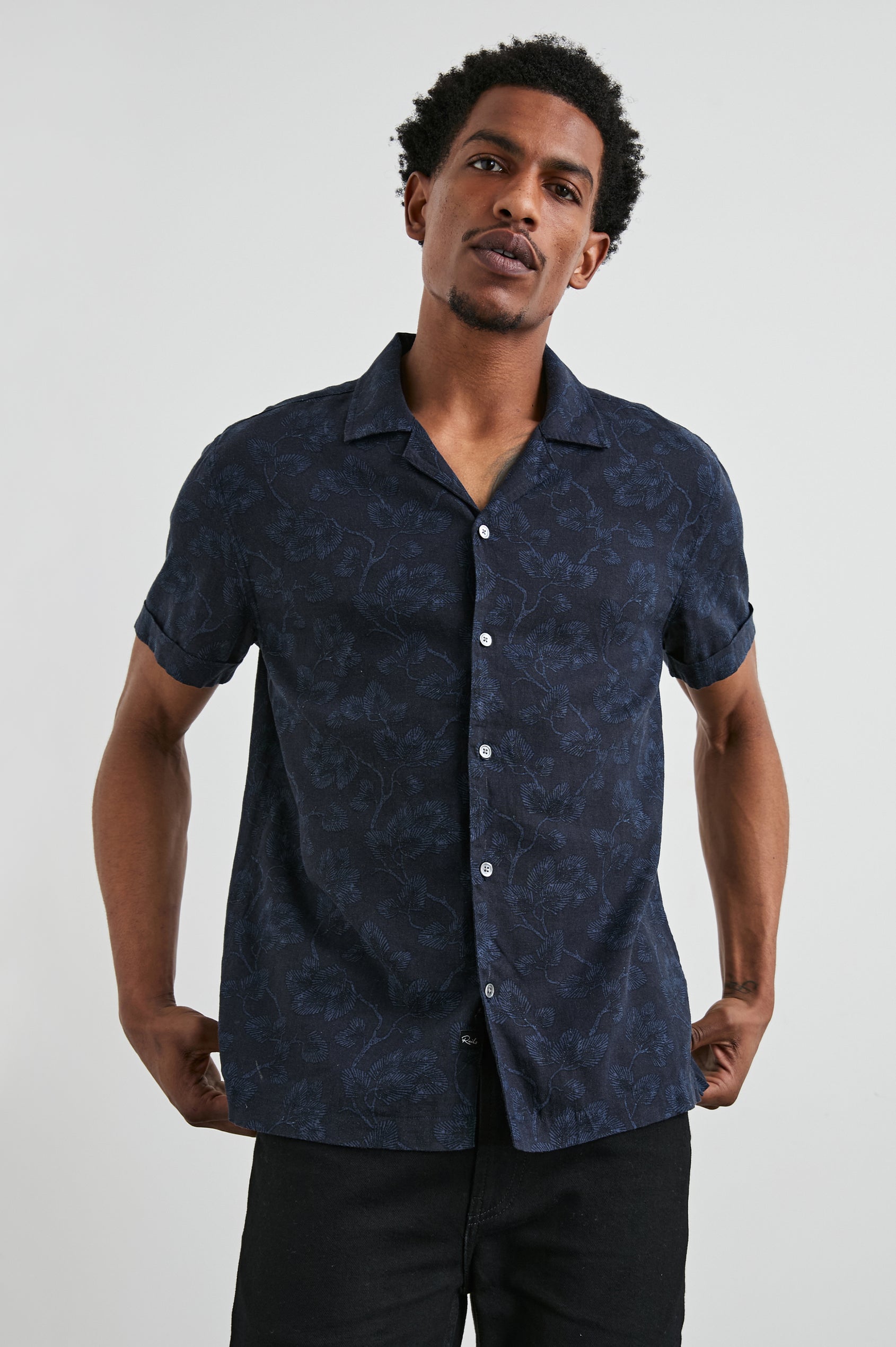 Amalfi Short-Sleeve Button Up in Japanese Maple Indigo Colorway, Indigo leaves on Black  - Front View Featured on Model