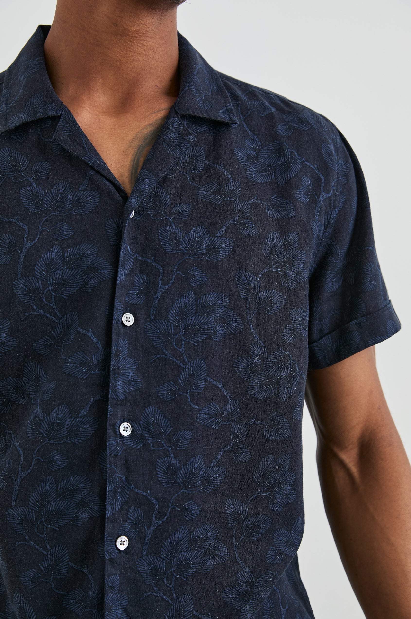 Amalfi Short-Sleeve Button Up in Japanese Maple Indigo Colorway, Indigo leaves on Black  - Front View Featured on Model