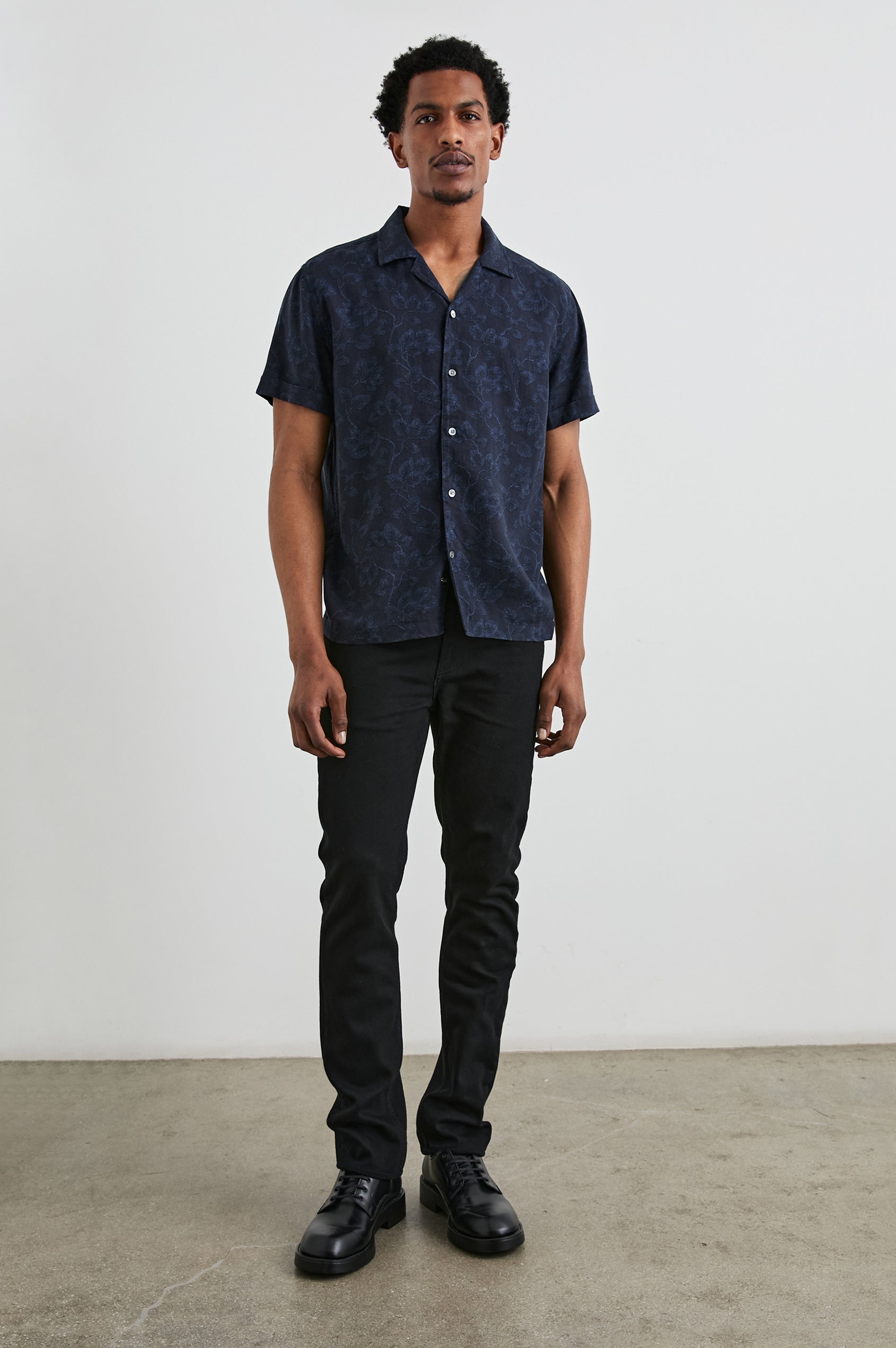 Amalfi Short-Sleeve Button Up in Japanese Maple Indigo Colorway, Indigo leaves on Black  - Front Full Body View Featured on Model