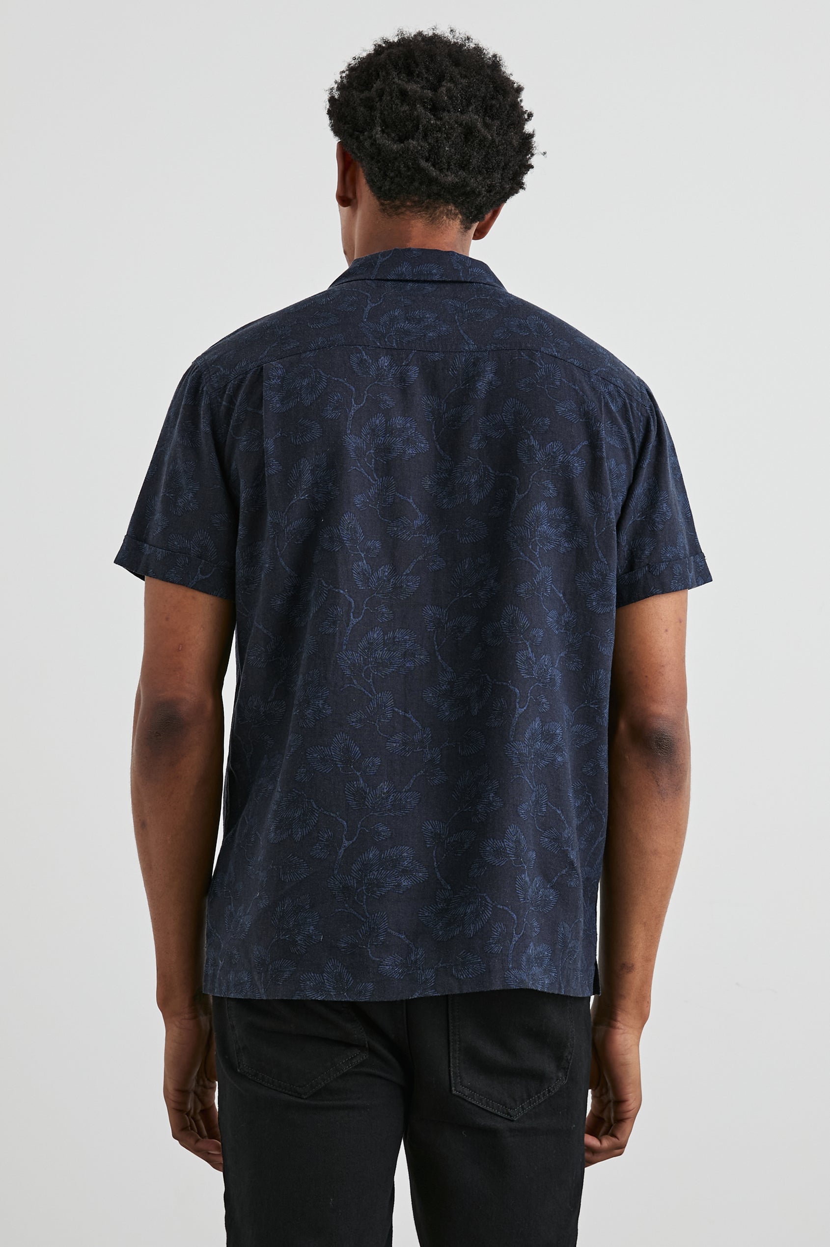 Amalfi Short-Sleeve Button Up in Japanese Maple Indigo Colorway, Indigo leaves on Black  - Back View Featured on Model