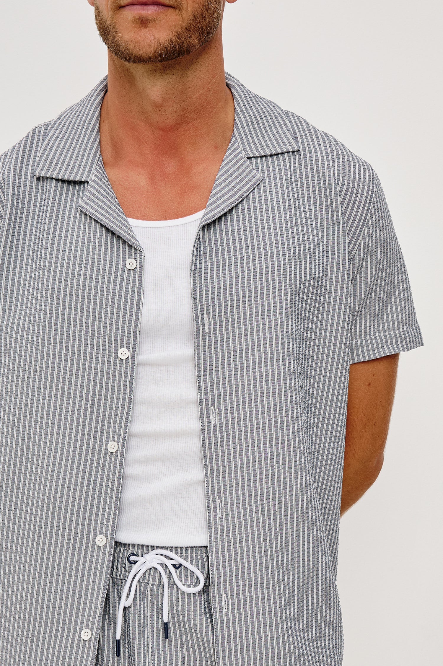 The Amalfi Button-Up Short Sleeve Shirt in Lightweight Stretch Linen-Blend With a Notched Collar and Classic Fit in Navy Deck Stripe - Upper Body Close Up Front View Featured on Model