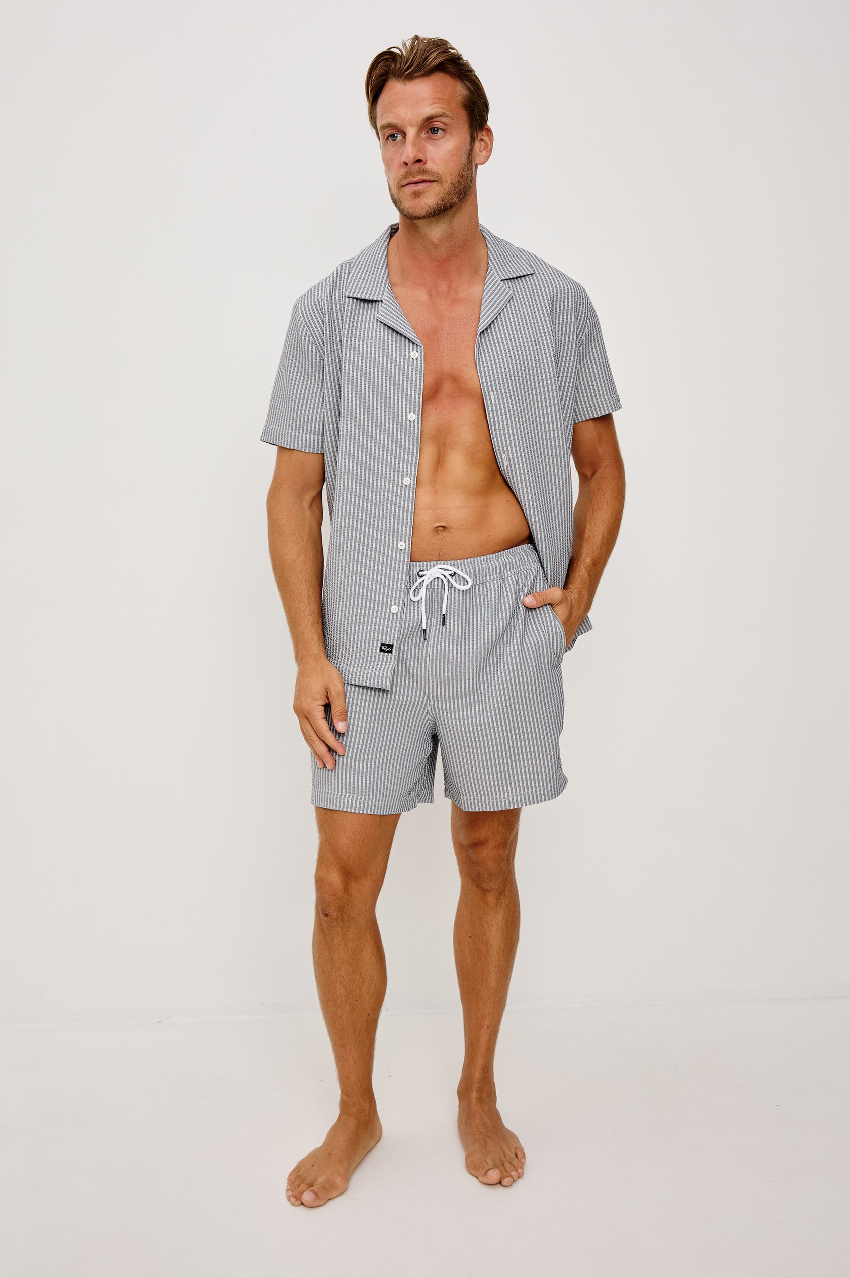 The Amalfi Button-Up Short Sleeve Shirt in Lightweight Stretch Linen-Blend With a Notched Collar and Classic Fit in Navy Deck Stripe - Full Body Front View Featured on Model