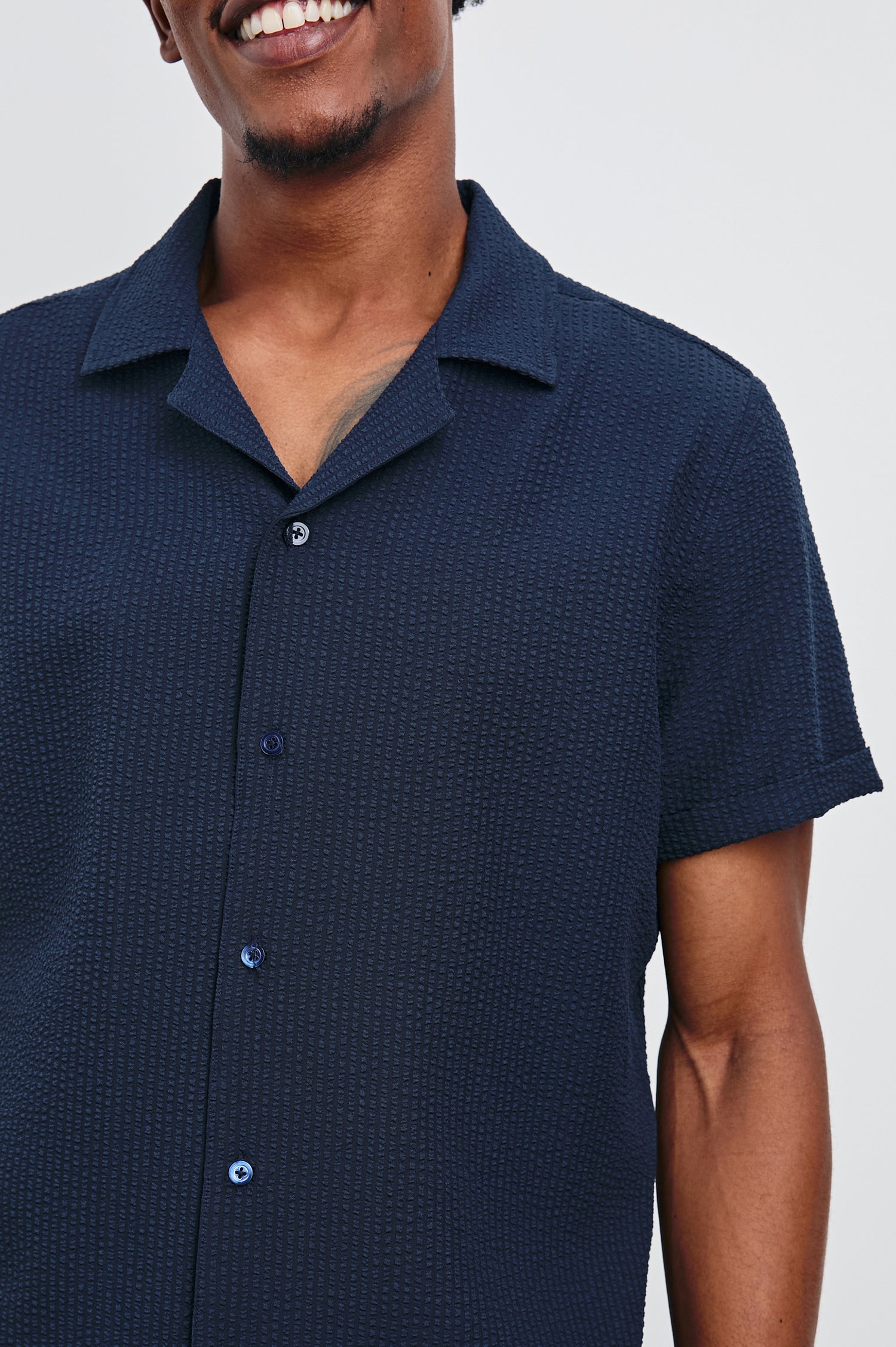 Amalfi Short-Sleeve Button Up in Navy Seersucker Colorway - Front View Featured on Model