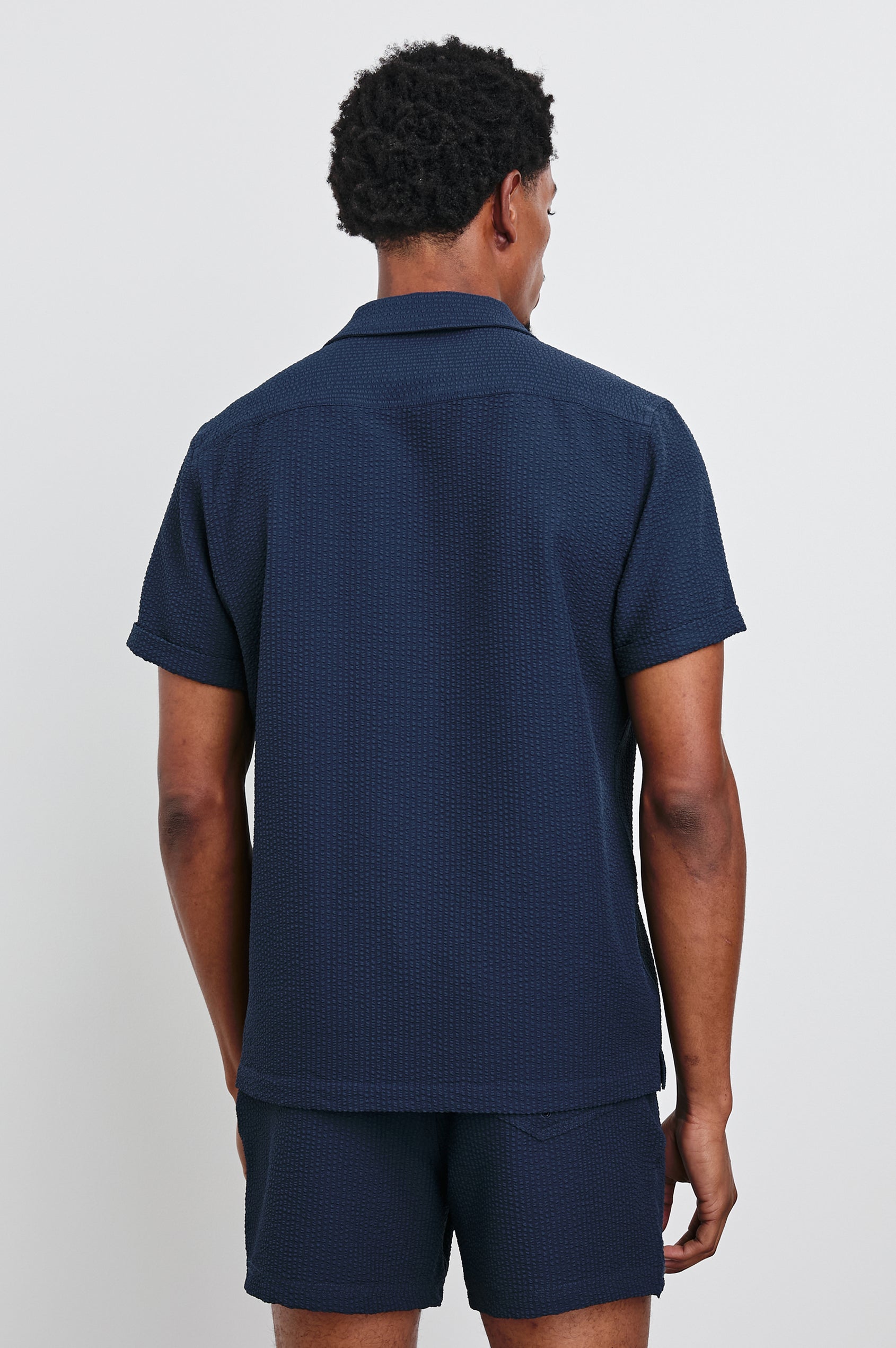 Amalfi Short-Sleeve Button Up in Navy Seersucker Colorway - Back View Featured on Model