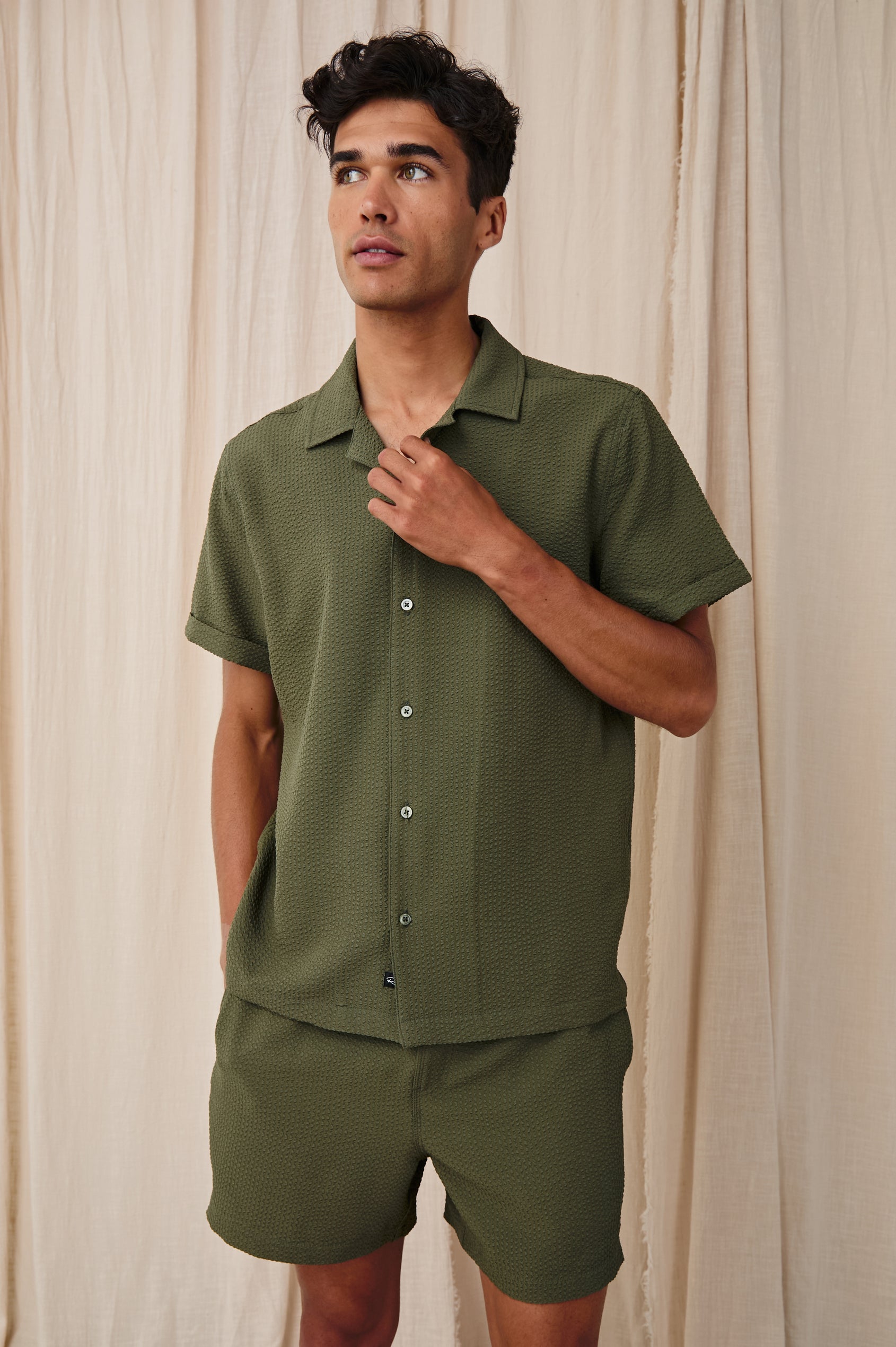 Amalfi classic fitted short sleeve button up shirt with collar in Olive Seersucker - stylized view on model, touching collar
