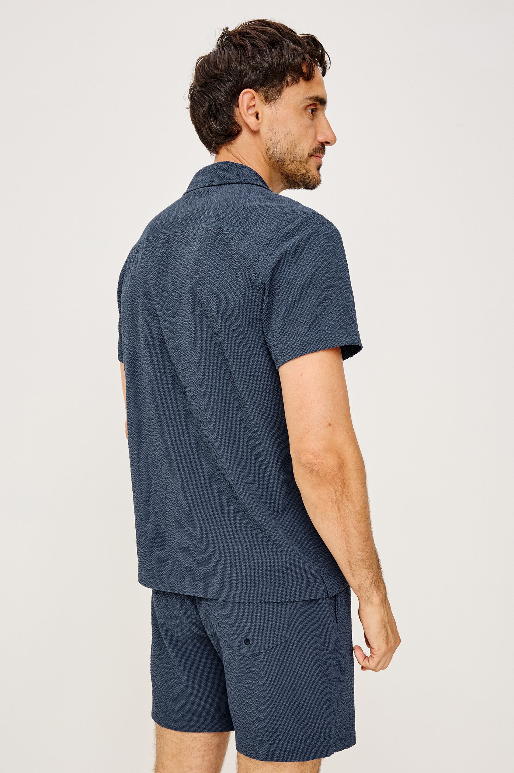 Amalfi Camp Shirt in Lightweight Seersucker With Notched Collar, Front Buttons, Short Sleeves, and Relaxed Fit in Stratos Colorway - Upper Body Back View Featured on Model