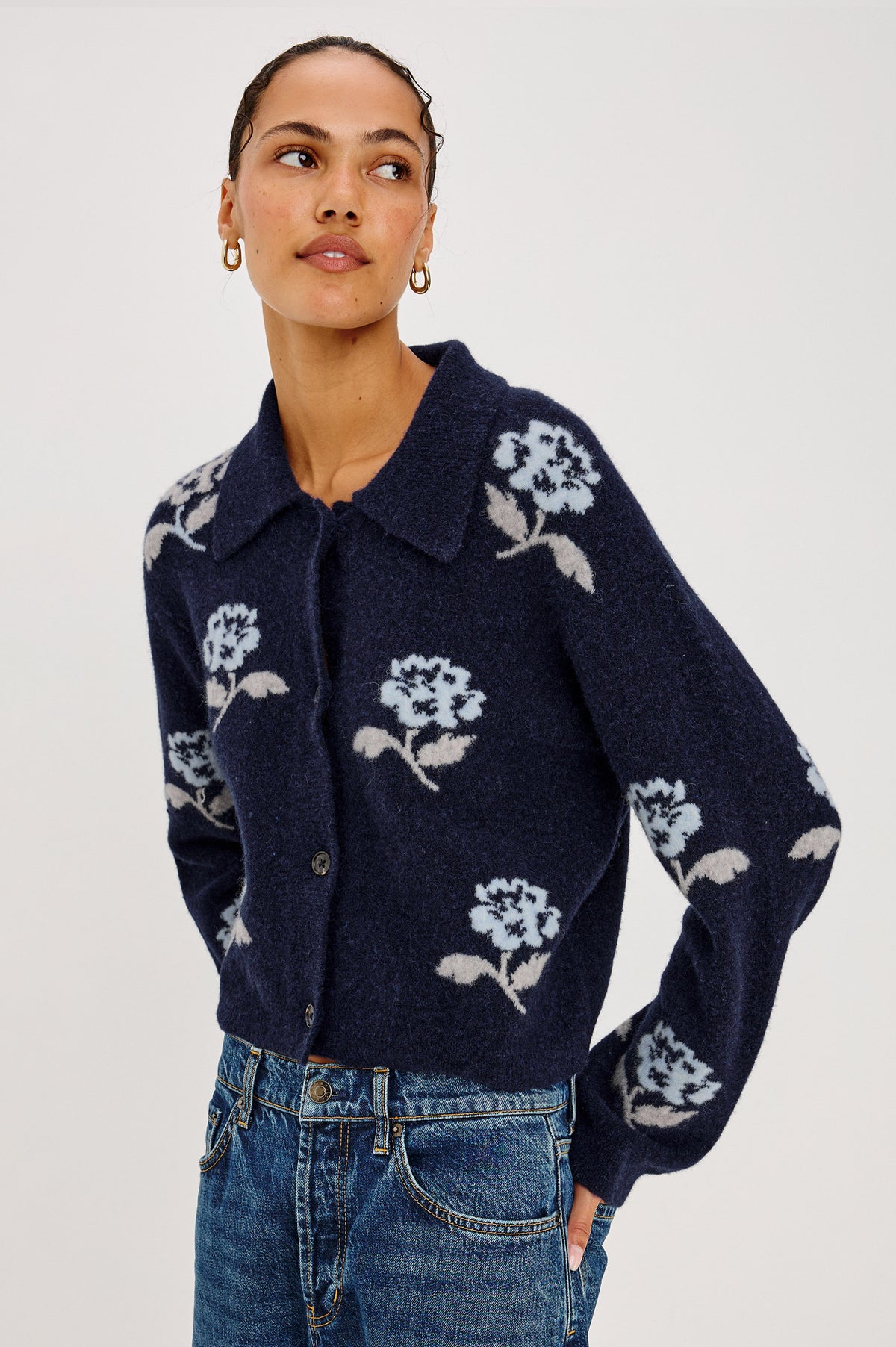 Amber Cardigan in Floral Jacquard Knit With Front Buttons, Point Collar, and Long Sleeves in Navy Petals Colorway - Upper Body Front View Featured on Model.