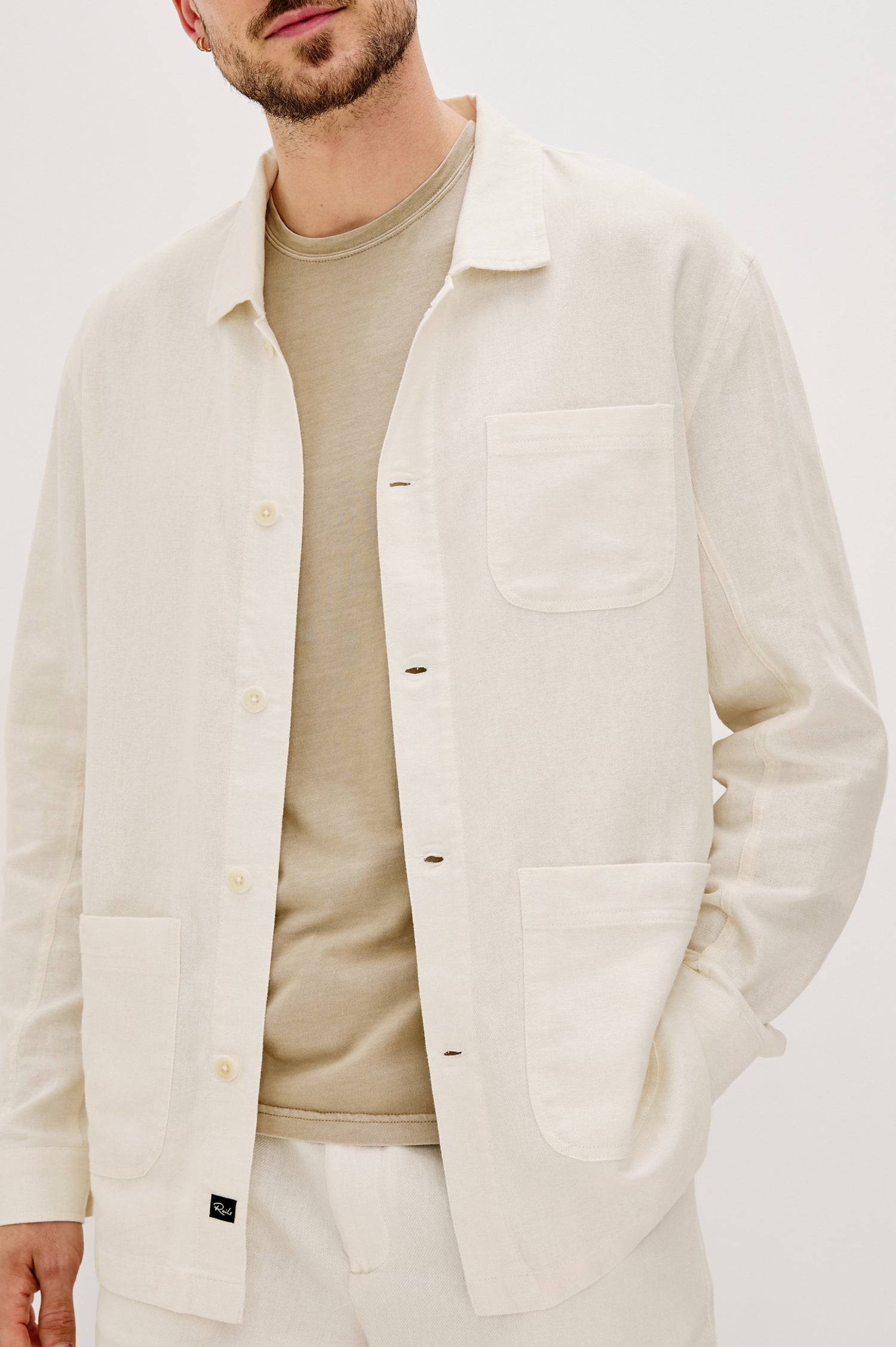Ambrose Button Front Chore Jacket with front Patch Pockets in Ecru Colorway. Front Detail View Shown on Model.