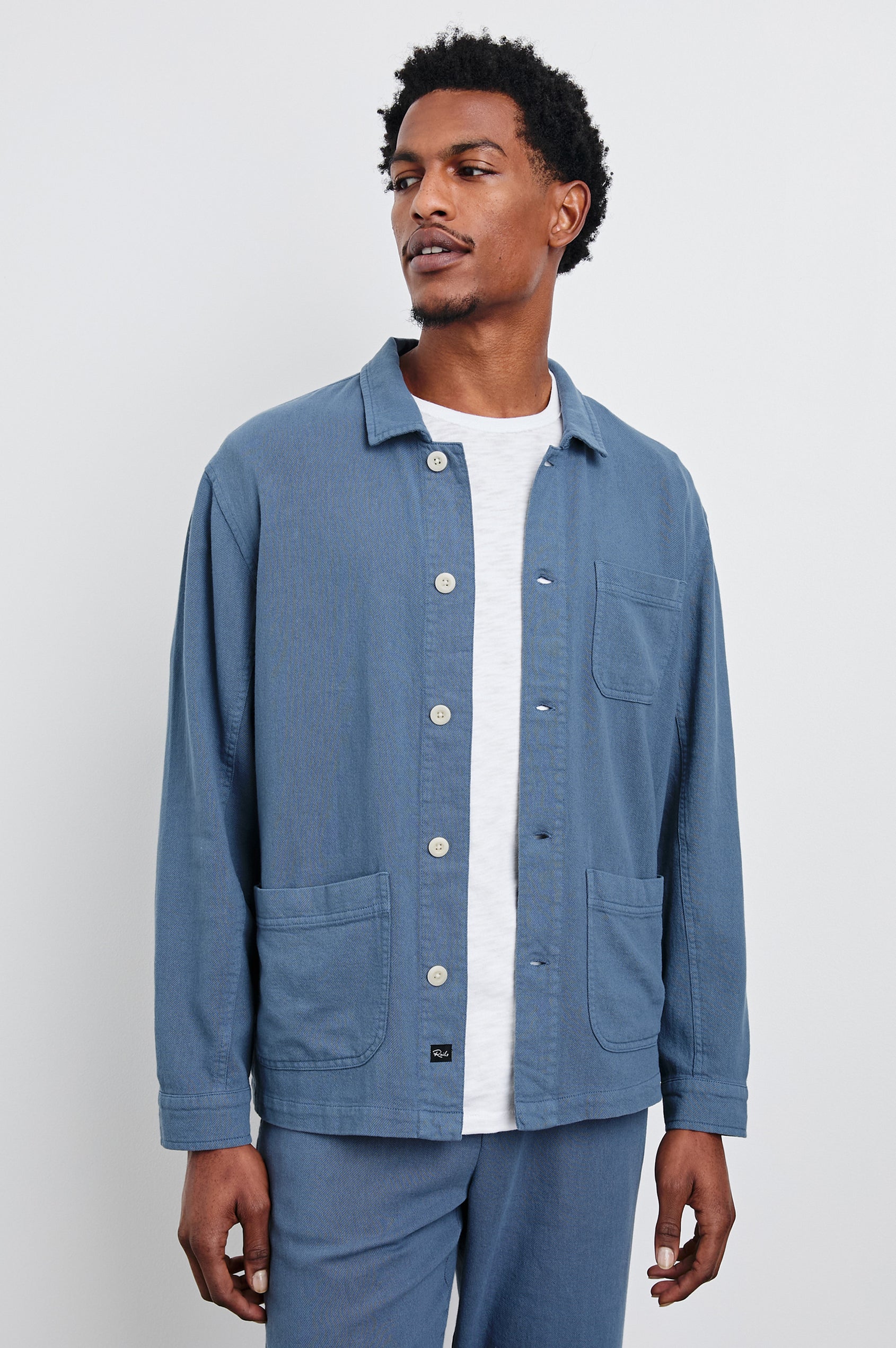 Ambrose Jacket with Button Closure, Tow Front Patch Pockets and a Chest Patch Pocket in Washed Blue Colorway - Front View Featured on Model