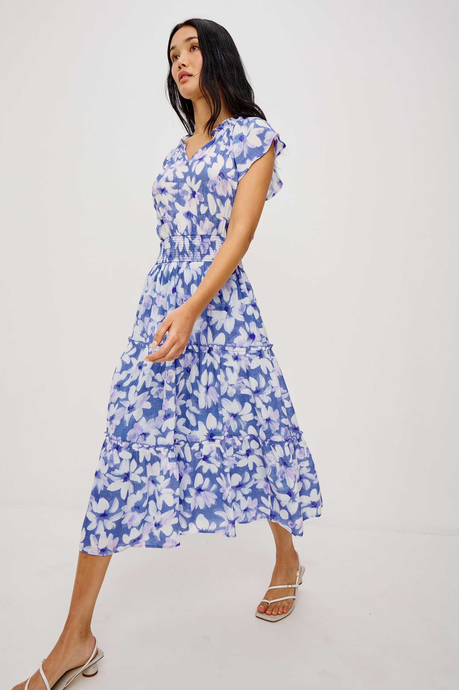 Amellia Midi Dress in Chiffon With Ruffled Split V-Neckline Flutter Sleeves a Smocked Waist and Tiered A-Line Skirt in Blue Ameranth Colorway - Full Body Front View Featured on Model