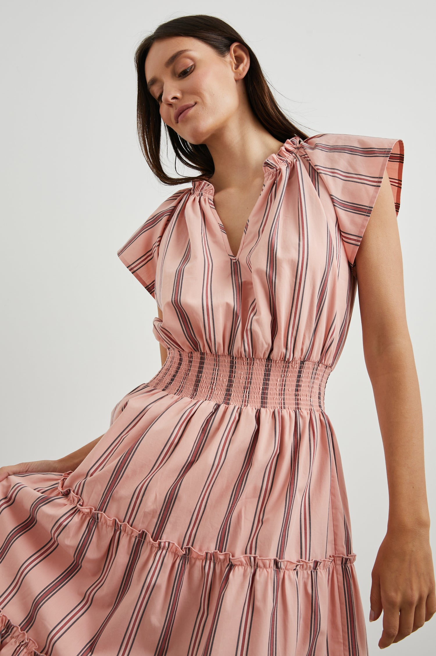 Amellia Short-Sleeve Midi Dress with Smocked Waist and Collar, V Neck, and a Tiered Skirt in Coral Navy Stripe Colorway, Vertical Coral and Navy Stripes on Peach - Front View Featured on Model
