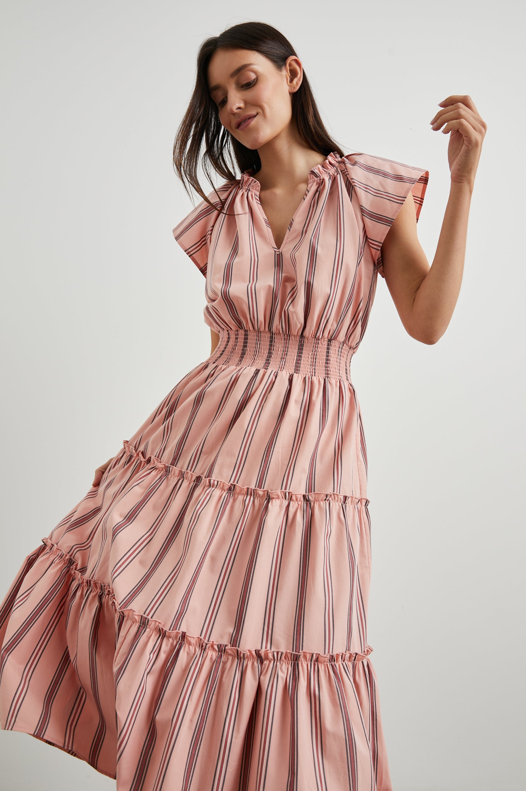 Amellia Short-Sleeve Midi Dress with Smocked Waist and Collar, V Neck, and a Tiered Skirt in Coral Navy Stripe Colorway, Vertical Coral and Navy Stripes on Peach - Front View Featured on Model