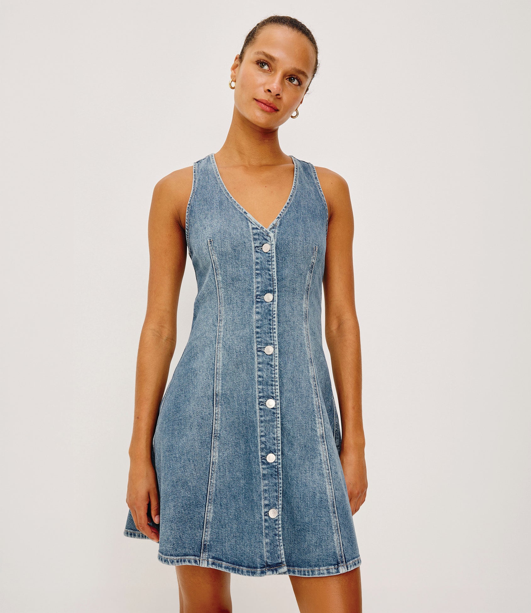 Ana Mini Dress in Comfort Stretch Denim With A-Line Cut, Front Seam Detailing, Front Buttons, and Adjustable Back Pull Tab in Heritage Blue Colorway - Upper Body Front View Featured on Model