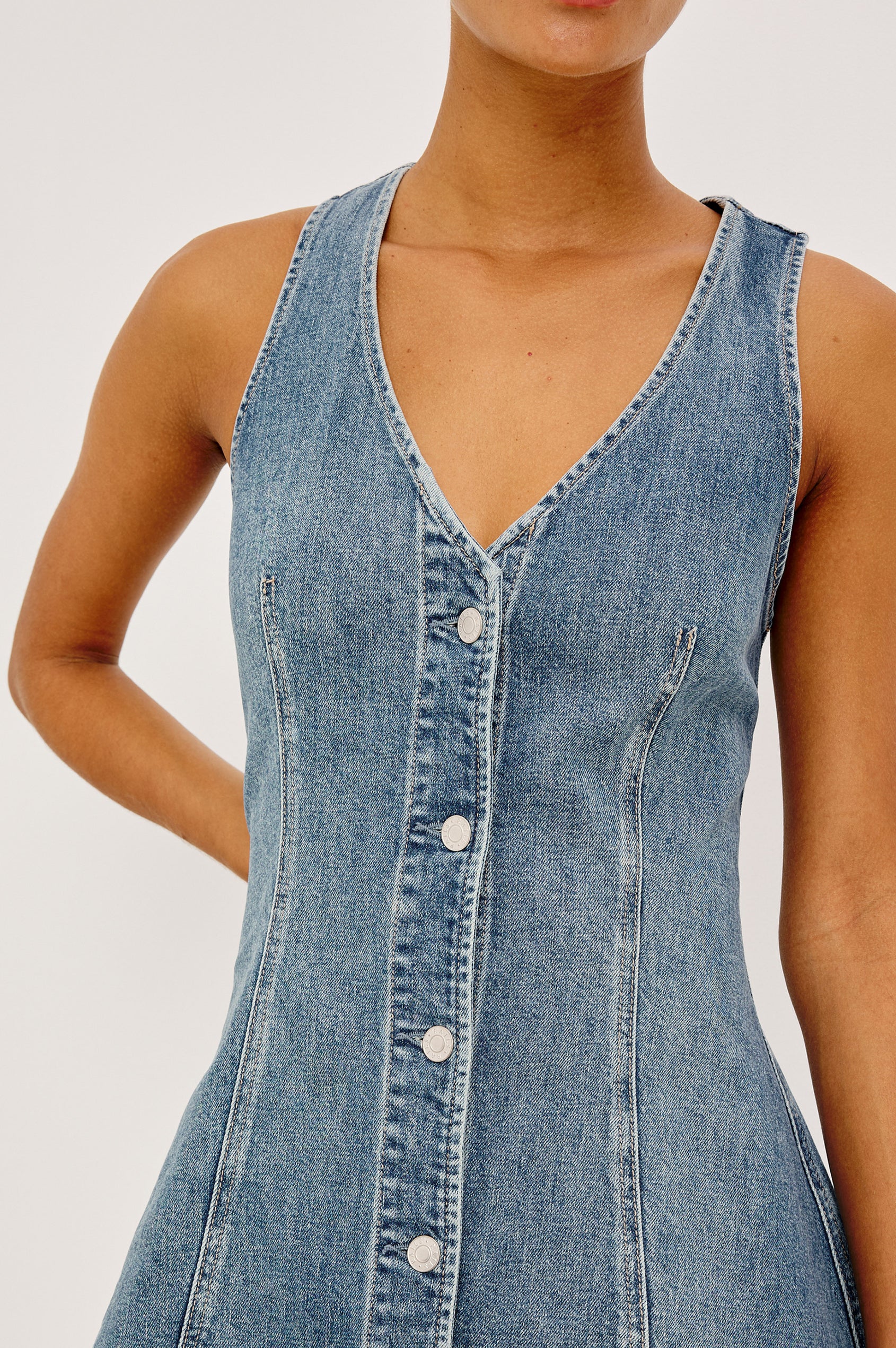 Ana Mini Dress in Comfort Stretch Denim With A-Line Cut, Front Seam Detailing, Front Buttons, and Adjustable Back Pull Tab in Heritage Blue Colorway - Upper Body Front View Featured on Model