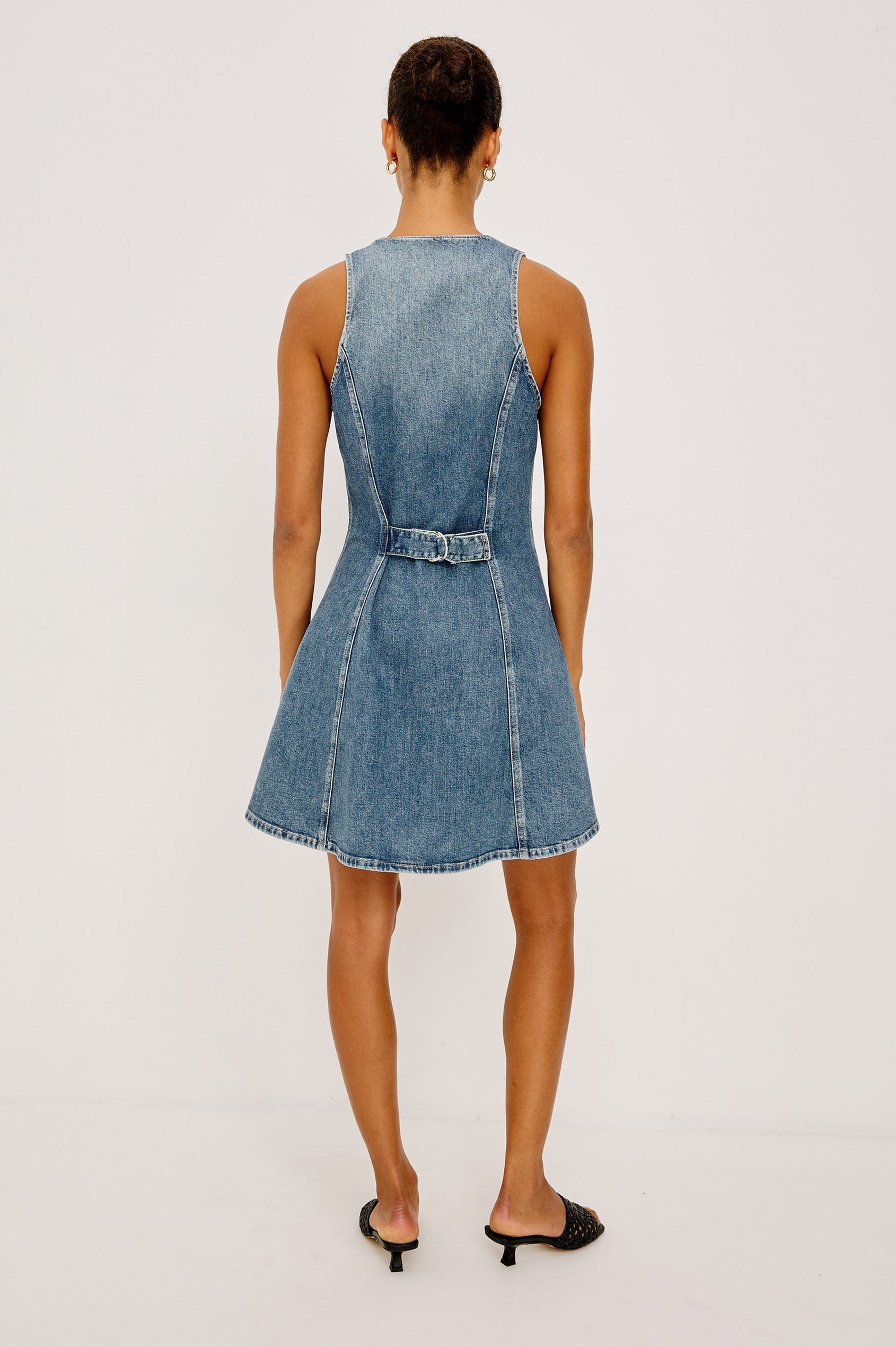 Ana Mini Dress in Comfort Stretch Denim With A-Line Cut, Front Seam Detailing, Front Buttons, and Adjustable Back Pull Tab in Heritage Blue Colorway - Full Body Back View Featured on Model